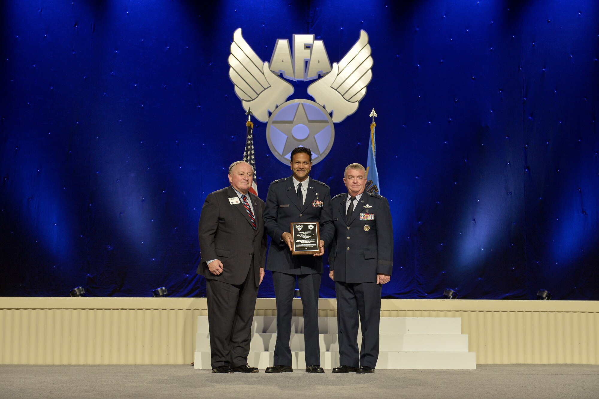 Lt. Col. (Dr.) Vikhyat S. Bebarta, Director, Enroute Care Research Center, Fort Sam Houston, Texas, is awarded the Air Force Association Paul W. Myers Award by George Muellner, AFA Chairman and Lt. Gen. (Dr.) Thomas Travis, Air Force Surgeon General, on Sept. 15, 2014 at the Gaylord Convention Center in National Harbor, Md.  

The Paul W. Myers Award is awarded to an Air Force Medical Corps Officer who has made the most significant contribution to the continued good health of the men and women of the USAF.  (Courtesy Photo)