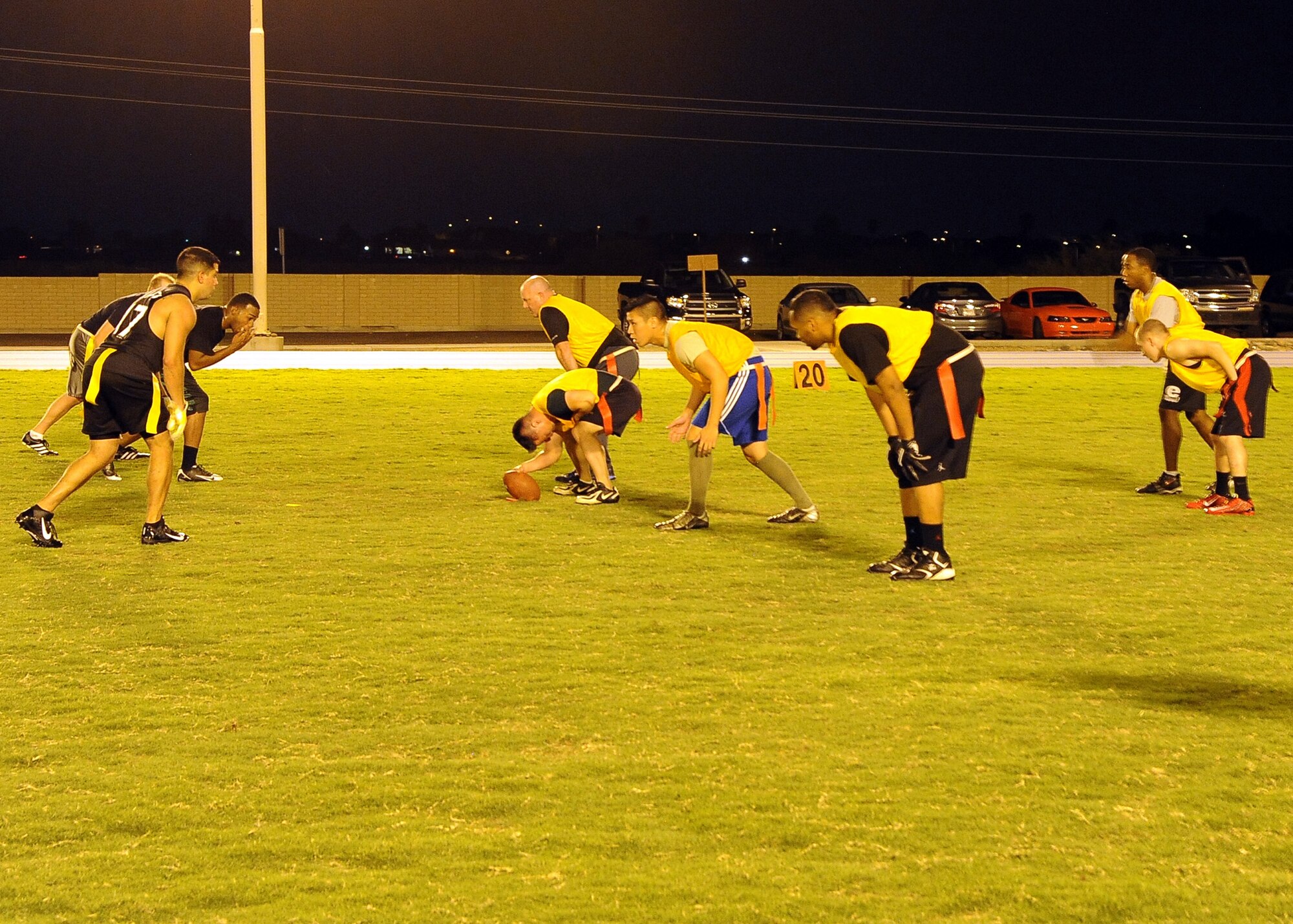 The 56th Fighter Wing Staff Agencies team prepares to hike the ball during an intramural flag football game against 56th Communications Squadron Sept. 10 at Luke Air Force Base. CS defeated FWSA 25-0. (U.S. Air Force photo/Airman 1st Class Pedro Mota)