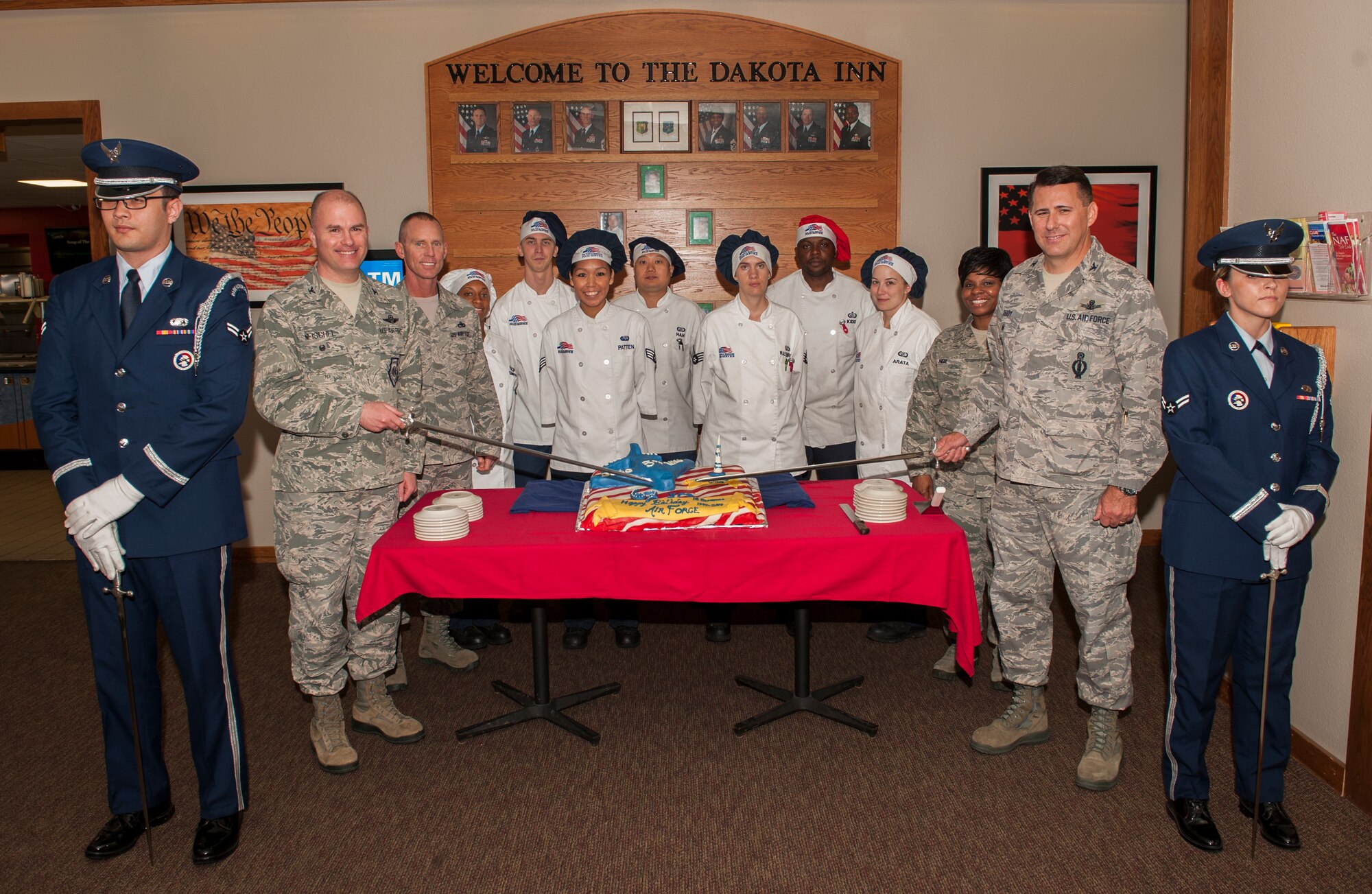 Minot Air Force Base leadership and chefs pose for a photo at the dining facility on Minot AFB, N.D., Sept. 18, 2014. The chefs made a birthday cake to celebrate the Air Force’s 67th birthday. (U.S. Air Force photo/Airman 1st Class Apryl Hall)