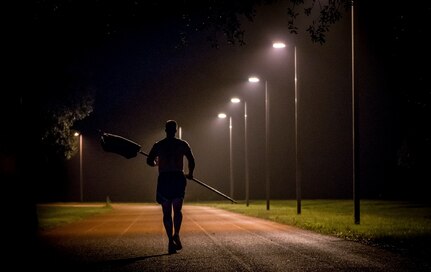 An Airman carries the Prisoner of War/Missing in Action flag during the POW/MIA Run Sept. 18, 2014, at Joint Base Charleston, S.C. Service members carried their respective service flags around the track while other service members carried the POW/MIA flag during the 24-hour vigil which went from 3:30 p.m. Sept. 18 to 3:30 p.m. Sept. 19, in honor of all POWs and MIAs. (U.S. Air Force photo/Senior Airman Dennis Sloan)
