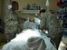 Maj. Joseph Thomas, 779th Medical Group Emergent Care Center flight commander, and Senior Airman Kristine Perez, 779th MDG ECC medical technician, care for a patient in the ECC, Sept. 11, 2014, on Joint Base Andrews. The presence of the ECC contributes to the immediate health and well-being of each member on Andrews by tending to patients with urgent conditions after hours. (U.S. Air Force photo/ Released)