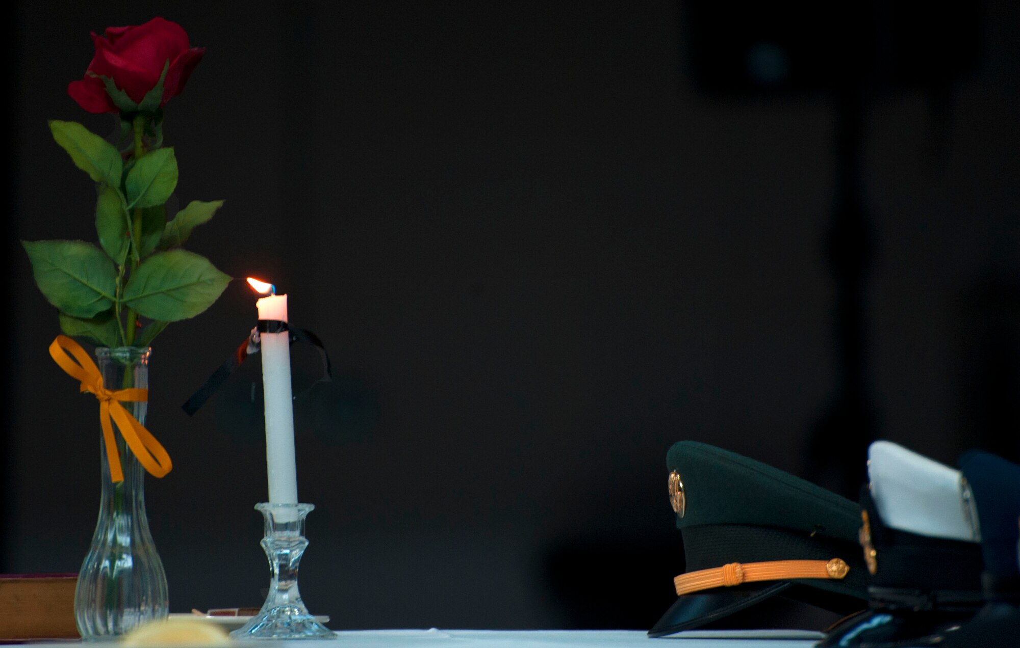 The service caps of each military branch sit on a table in the Fall Hall Community Center Sept. 16 during the prisoners of war and missing in action ceremony in observance of POW and MIA remembrance week . The table remains empty in remembrance of the men and women who never returned home. (U.S. Air Force photo by Airman 1st Class Brandon Valle)
