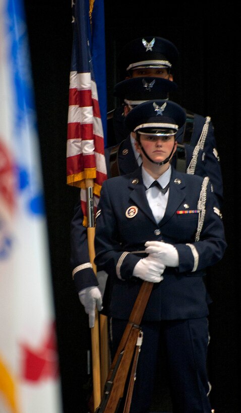Airmen 1st Class Siobhan Lynch, Javon Hill-Gee, Kristen Pressler and Eric Feigner, 90th Missile Wing ceremonial guardsmen, prepare to post the colors Sept. 16 during F.E. Warren Air Force Base's prisoners-of-war and missing-in-action ceremony in the Fall Hall Community Center as part of Warren's POW and MIA Remembrance Week events.  The ceremony consisted of the posting of the colors, a symbolic demonstration setting of the POW and MIA table, and a story of the experiences of a prisoner of war during the Vietnam conflict. (U.S. Air Force photo by Airman 1st Class Brandon Valle)