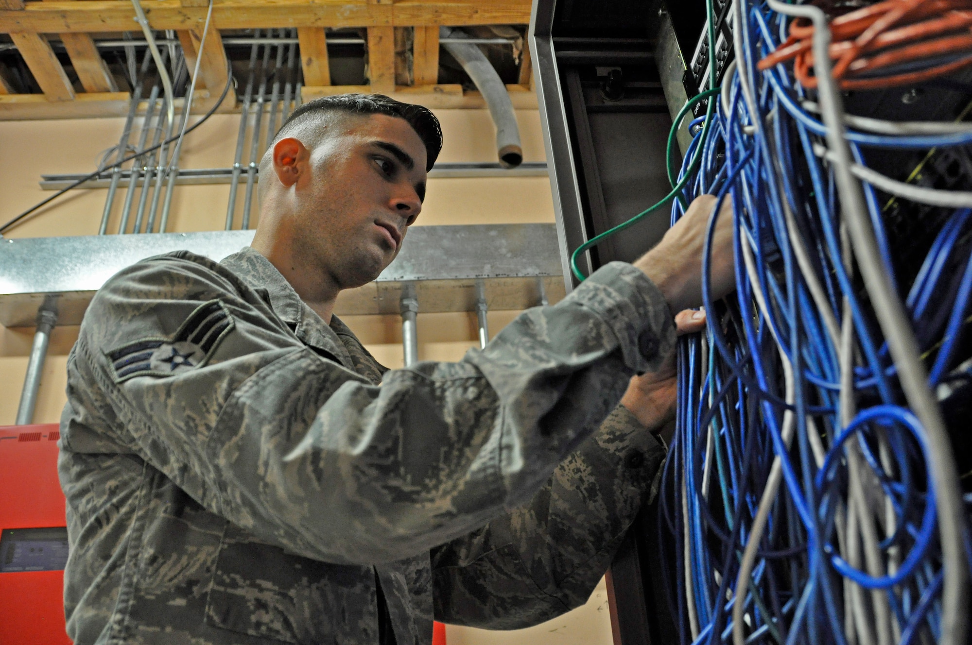 Senior Airman David Montano, Client Systems Technician at the 482nd Communications Squadron, checks port security in a "Comm Closet" at Homestead Air Reserve Base, Fla., as part of the Command Cyber Readiness Inspection Aug. 4-8. The CCRI is a triennial inspection conducted by the Defense Information Systems Agency to assess the compliance status and operational readiness of Homestead's non-secure internet protocol router, NIPR. It also assesses the secure internet protocol router, SIPR, as well as traditional and physical security of base facilities. (U.S. Air Force photo by Senior Airman Nicholas Caceres)
