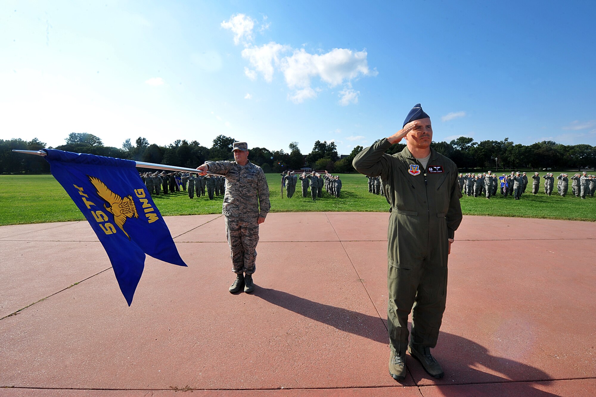 U.S. Air Force Chief Master Sgt. Matthew Grengs, 55th Wing command chief, holds the 55th WG guidon while U.S. Air Force Col. Thatcher Cardon, 55th Aerospace Medicine Squadron commander, salutes the U.S. flag during the Air Force Birthday retreat ceremony on the parade grounds Sept. 18. The Department of the Air Force was created when President Harry S. Truman signed the National Security Act of 1947. (U.S. Air Force Photo by Charles Haymond)