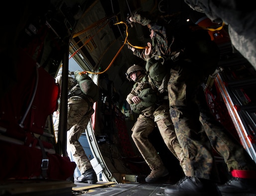 Paratroopers jump out of a U.S. Air Force C-130J Super Hercules assigned to the 37th Airlift Squadron, Eindhoven, Netherlands, Sept. 20, 2014. Paratroopers from eight nations came to the Netherlands to reenact the jumps made during Operation Market Garden 70 years ago. The commemoration was held to honor those who lost their life to liberate the Netherlands. (U.S. Air Force photo/Senior Airman Damon Kasberg)