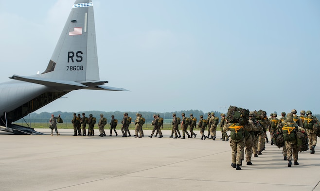 Paratroopers from different nations prepare to enter a U.S. Air Force C-130J Super Hercules assigned to the 37th Airlift Squadron, Eindhoven, Netherlands, Sept. 20, 2014. Paratroopers from eight nations came to the Netherlands to reenact the jumps made during Operation Market Garden 70 years ago. The commemoration was held to honor those who lost their life to liberate the Netherlands. (U.S. Air Force photo/Senior Airman Damon Kasberg)