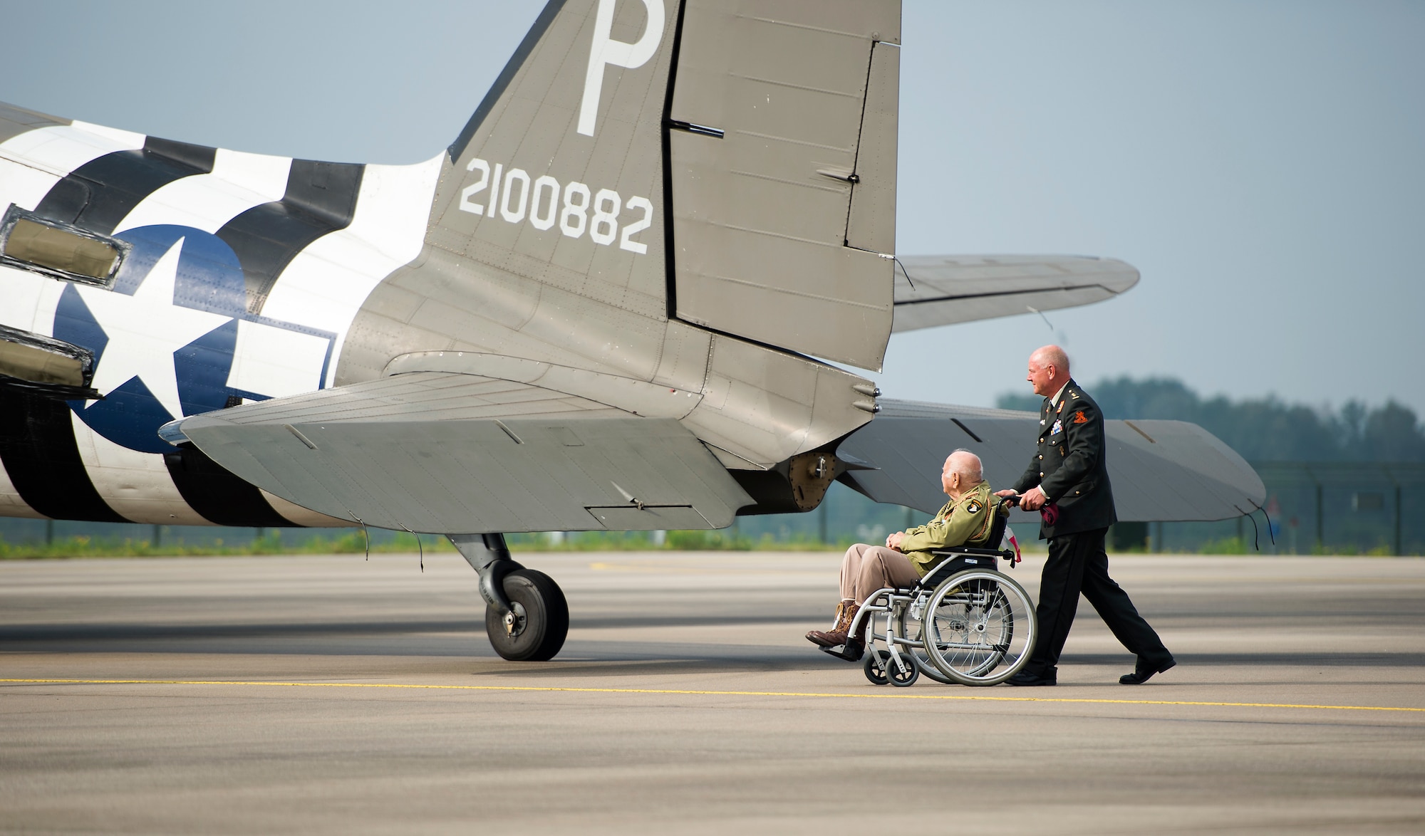 Then U.S. Army Private 1st Class Mario Patruno, 101st Airborne Division, 506th Company F paratrooper, gazes at a C-47 Skytrain, Eindhoven, Netherlands, Sept. 20, 2014. Patruno participated in both D-Day and Operation Market Garden 70 years ago. During the commemoration of Operation Market Garden he visited with paratroopers before they reenacted the exact jump he made all those years ago. (U.S. Air Force photo/Senior Airman Damon Kasberg)
