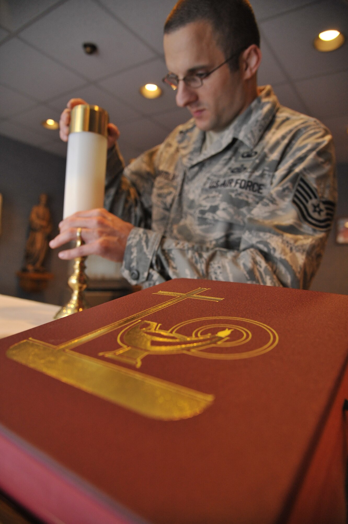 U.S. Air Force Tech. Sgt. Lukas Bartels, 509th Bomb Wing chaplain assistant, prepares altar candles for daily Mass at Whiteman Air Force Base, Mo., Sept. 3, 2014. A big part of a chaplain assistant’s job is pastoral care. This involves religious support teams which normally comprised of one chaplain to one chaplain assistant.  They do unit engagements which entails the chaplain and chaplain assistant going to different squadrons to follow up with Airmen who requested their assistance. (Air Force photo by Airman 1st Class Keenan Berry/Released)