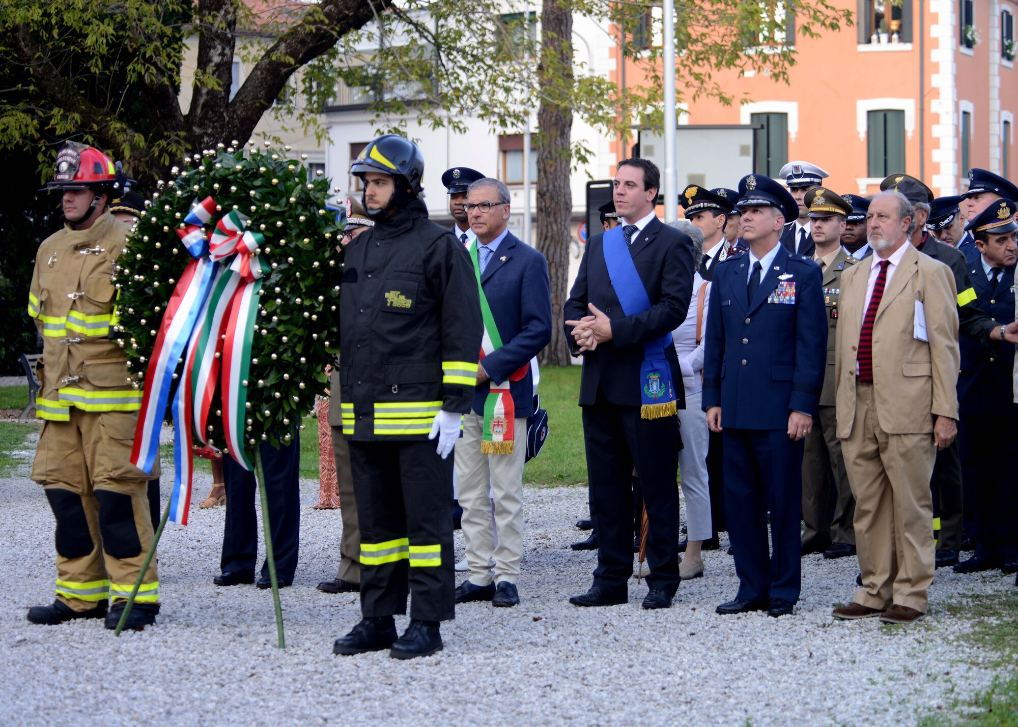 Italian civic leaders and 31st Fighter Wing personnel pause before placing place a wreath at the Monumenta ai Caduti during the 13th Annual Italian-American Friendship Festival on Sept. 20, 2014, at Sacile, Italy, to honor the lives lost on 9/11. The festival gave Team Aviano the opportunity to strengthen bonds with their Italian neighbors. (U.S. Air Force photo/Airman 1st Class Deana Heitzman)  