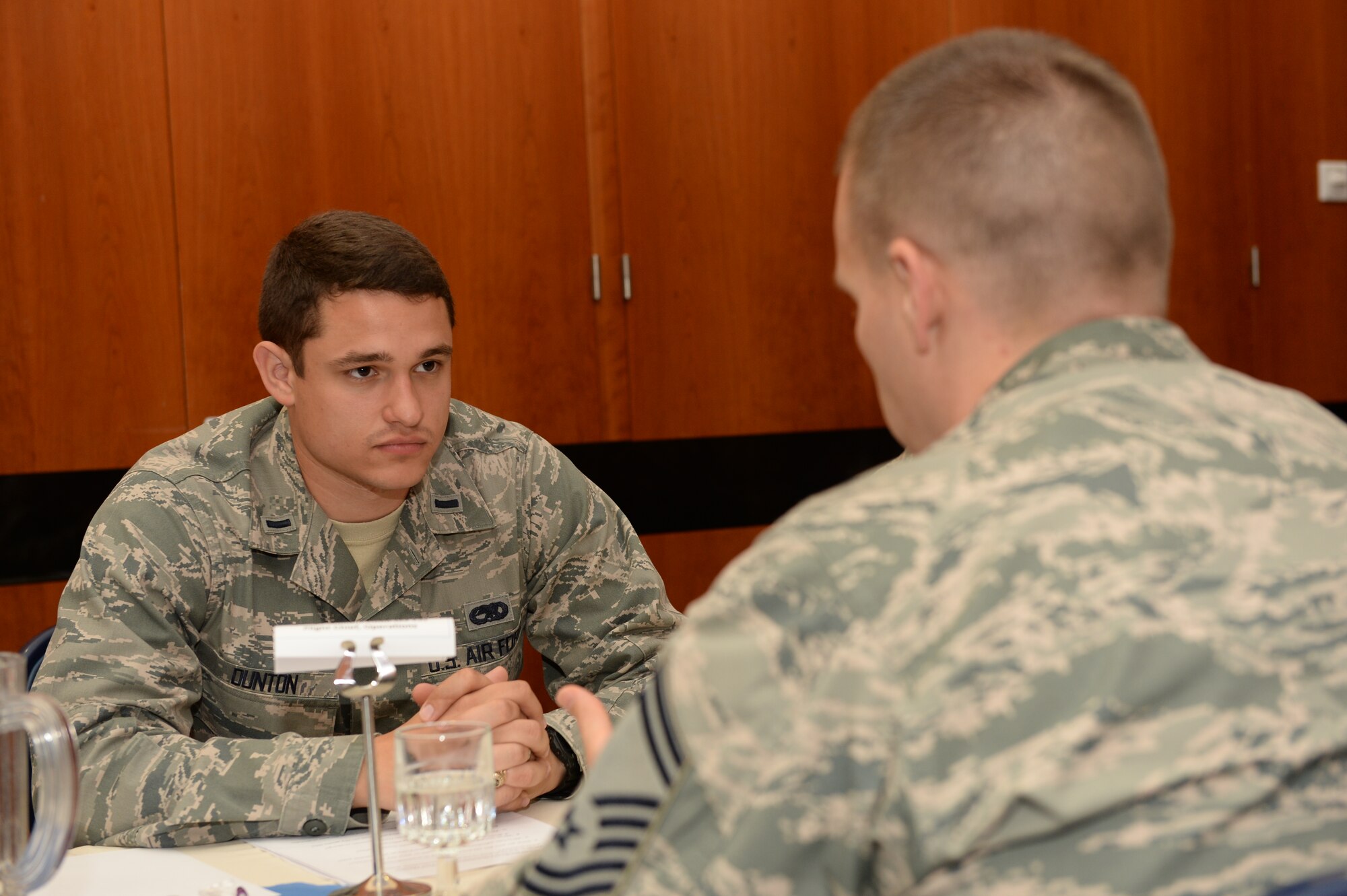 U.S. Air Force 1st Lt. Jonathan Dunton, 52nd Equipment Maintenance Squadron munitions maintenance section officer in charge from Dallas, left, listens to U.S. Air Force Senior Master Sgt. William Hebb, 52nd Communication Squadron operations flight chief from St. Albans, W. Va., during the 52nd Fighter Wing’s inaugural speed mentoring event Sept. 19, 2014, at Spangdahlem Air Base, Germany. More than 50 Airmen took part in the event, either as a mentor or mentee. (U.S. Air Force photo by Airman 1st Class Dylan Nuckolls/Released)