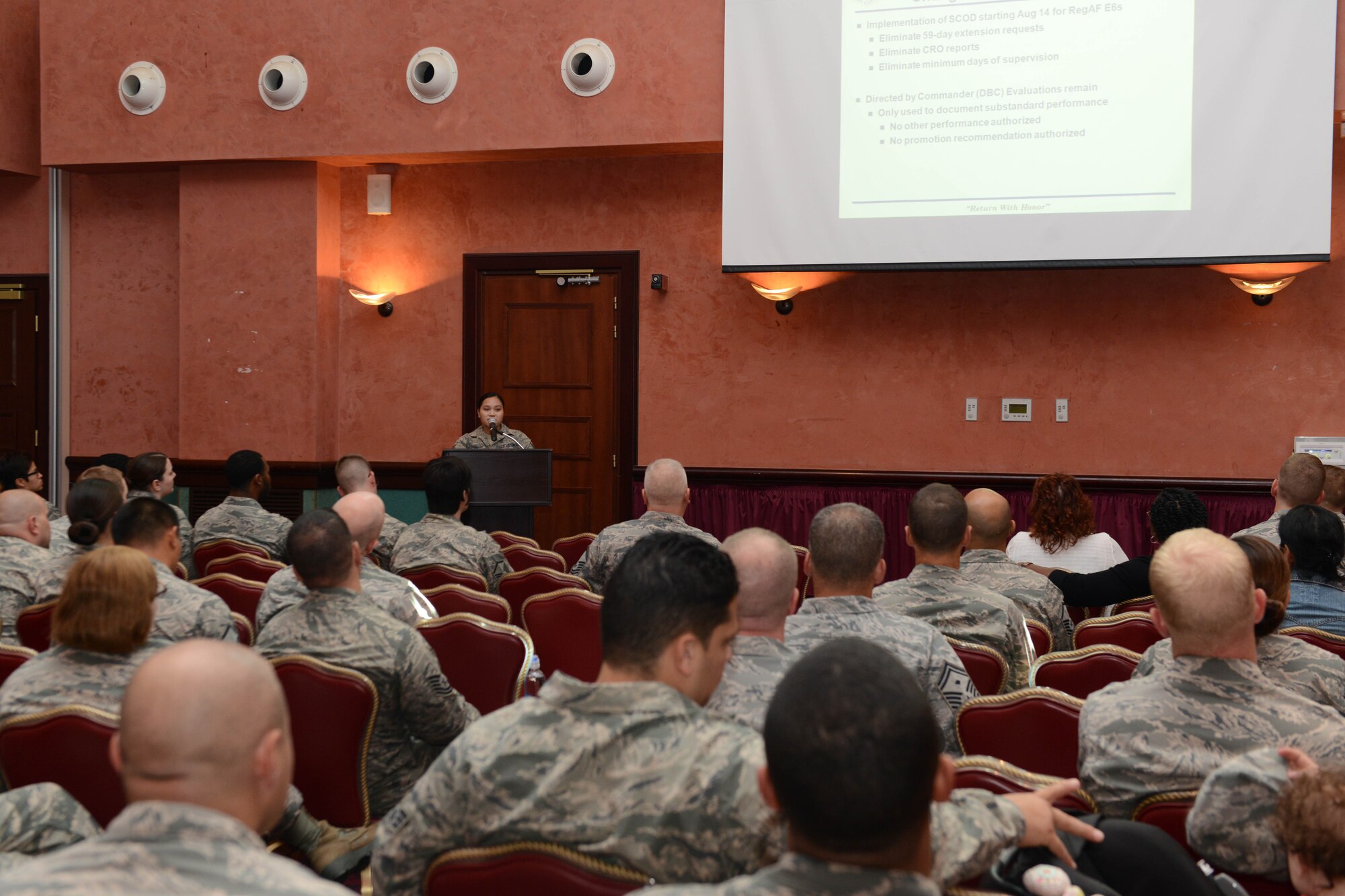 Tech. Sgt. Grace Barce, 31st Force Support Squadron force management NCO in charge, answers a question regarding a change in the Weighted Airmen Promotion System testing during a town hall, Sept. 22, 2014, at Aviano Air Base, Italy. Three representatives from home fuels, the education center and force management department hosted the town hall to educate Airmen on recent changes to Aviano AB policies. (U.S. Air Force photo/Airman 1st Class Ryan Conroy) 