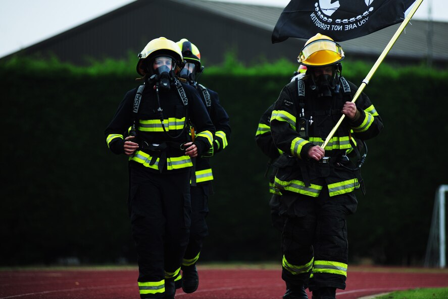 Firefighters from the 423rd Civil Engineer Squadron complete a lap in full gear during a POW/MIA Recognition Run at RAF Alconbury, United Kingdom, Sept. 19, 2014. All participating firefighters were British nationals who came out to show their support for prisoners of war and missing in action personnel from all nations. (U.S. Air Force photo by Staff Sgt. Jarad A. Denton/Released)