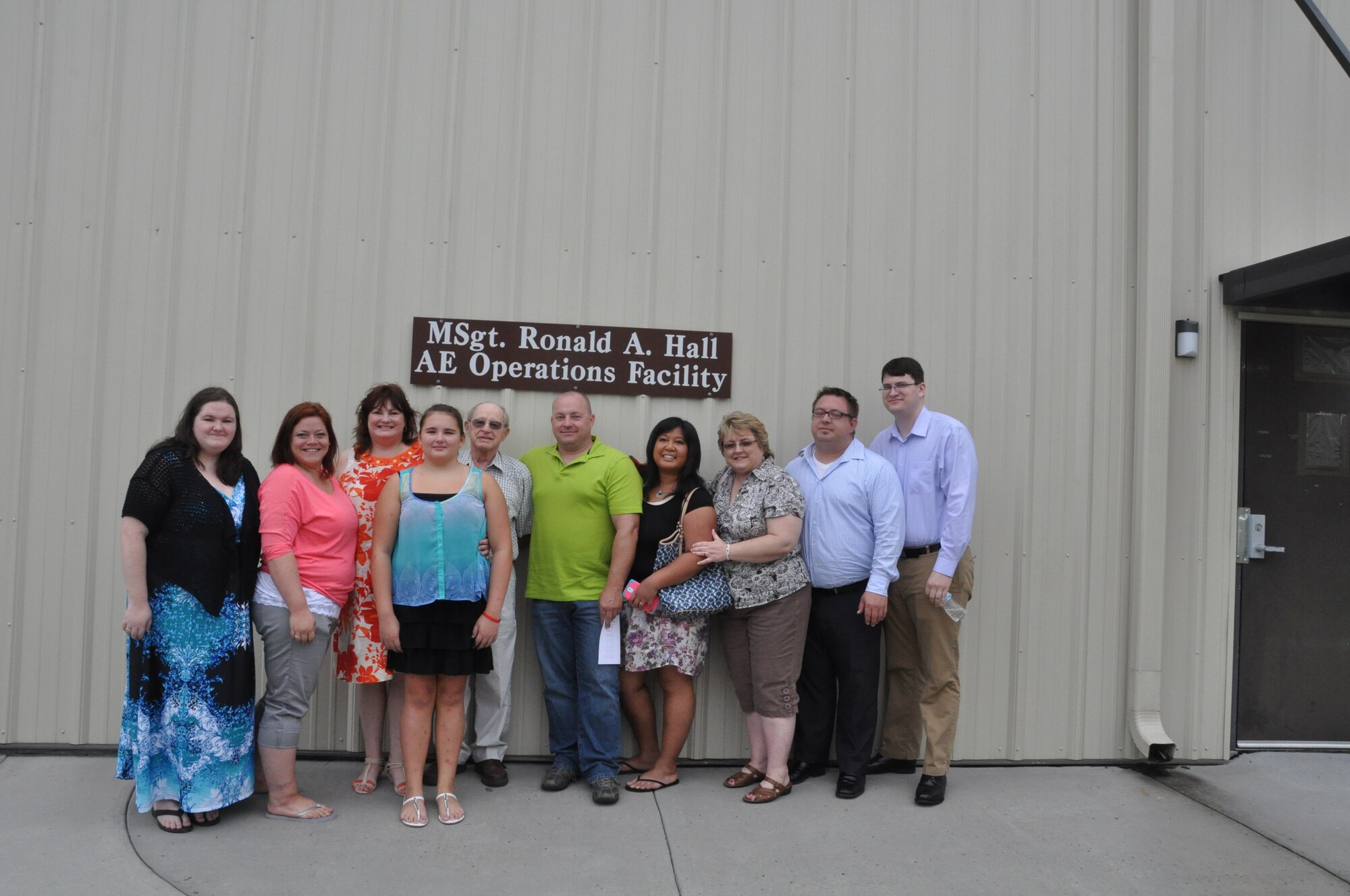 Family members stand in front of the new sign designating Building 416 as the Master Sergeant Ronald A. Hall Aeromedical Evacuation Operations Facility. The building received its name during a dedication ceremony held Sept. 21, 2014 at Joint Base Charleston, S.C. Master Sgt. Ronald Hall spent 24 of his 28 years in the Air Force as a member of the 315th Aeromedical Evacuation Squadron. After years of dedicated service to the military, Hall passed away in May 2011. U.S. Air Force photo by Capt. Michaela Judge)