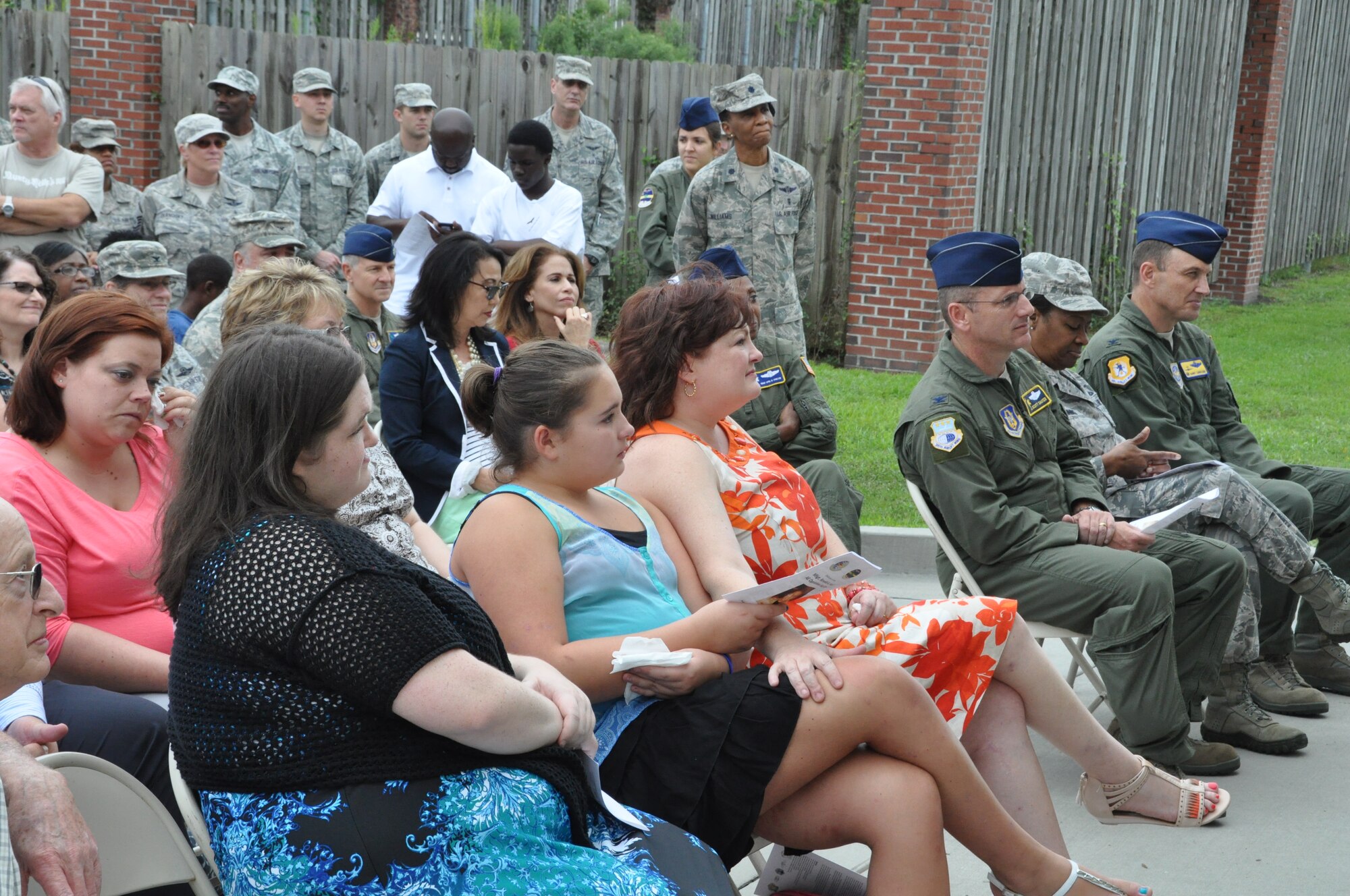 Rosemary Green-Hall, wife of Master Sergeant Ron Hall, daughters Emily and Sarah, and father-in-law Ronald H. Hall listen in as remarks are made during a dedication ceremony held Sept 21, 2014 at Joint Base Charleston, S.C. Building 416 was officially designated as the Master Sergeant Ronald A. Hall Aeromedical Evacuation Operations Facility. Master Sgt. Ronald Hall spent 24 of his 28 years in the Air Force as a member of the 315th Aeromedical Evacuation Squadron. After years of dedicated service to the military, Hall passed away in May 2011. U.S. Air Force photo by Capt. Michaela Judge)