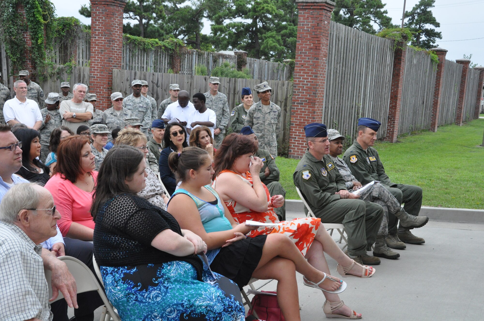 Rosemary Green-Hall, wife of Master Sergeant Ron Hall, daughters Emily and Sarah, and father-in-law Ronald H. Hall listen in as remarks are made during a dedication ceremony held Sept 21, 2014 at Joint Base Charleston, S.C. Building 416 was officially designated as the Master Sergeant Ronald A. Hall Aeromedical Evacuation Operations Facility. Master Sgt. Ronald Hall spent 24 of his 28 years in the Air Force as a member of the 315th Aeromedical Evacuation Squadron. After years of dedicated service to the military, Hall passed away in May 2011. U.S. Air Force photo by Capt. Michaela Judge)