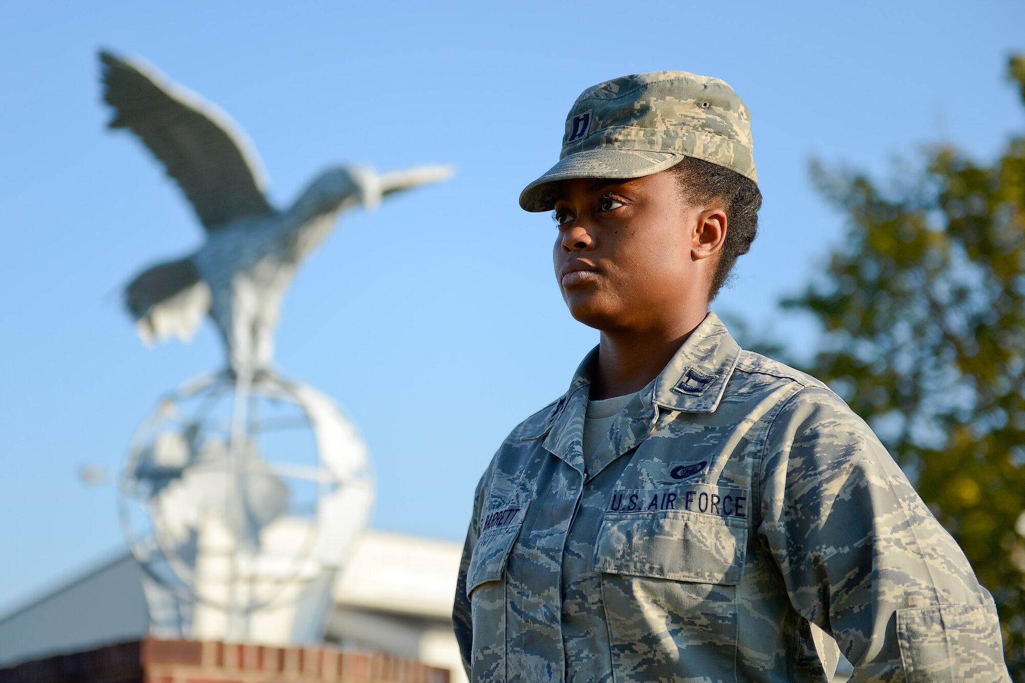 Capt. Emma Barrett, 436th Operations Support Squadron intelligence officer, stands stoic in the early morning light while participating in the POW/MIA Remembrance Day vigil conducted by the 436th Airlift Wing Sept. 19, 2014, at Dover Air Force Base, Del. The 436th AW is known as the 'Eagle Wing' and the eagle on a globe statue is the official emblem of the wing. (U.S. Air Force photo/Greg L. Davis)