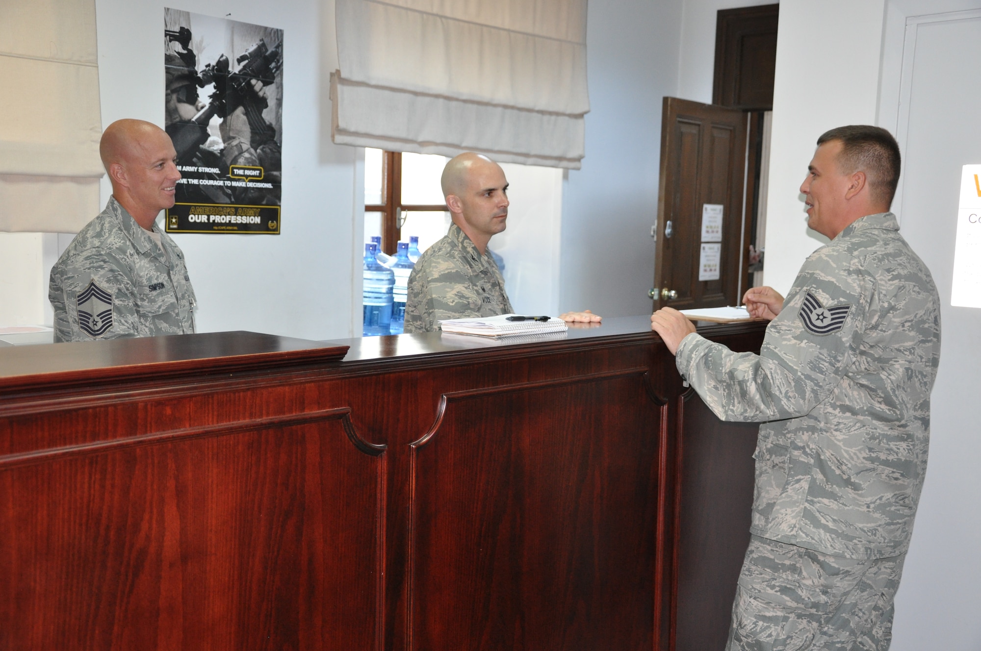 Tech. Sgt. Mircea Rosculet, 425th Air Base Squadron finance NCOIC customer service,
briefs Col. Russell Voce, 39th Mission Support Group commander, and Chief Master Sgt. 
Chris Simpson, about the customer services provided to Izmir community members,  at NATO 
Sept. 15, 2014. (US Air Force Photo by Tanju Varlikli/Released) 
