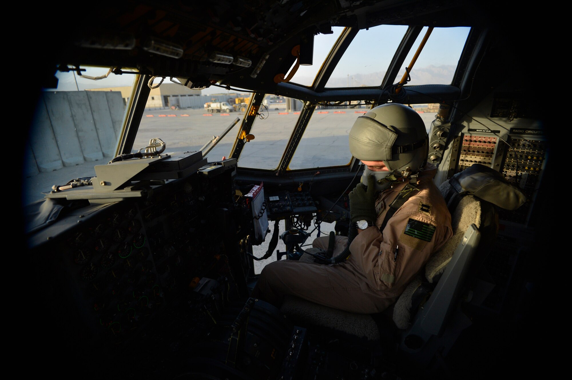 U.S. Air Force Capt. Frank Von Heiland, 41st Expeditionary Electronic Combat Squadron co-pilot, checks his oxygen mask on an EC-130H Compass Call aircraft at Bagram Airfield, Afghanistan Sept. 12, 2014.  The 41 EECS provides premier counter-communications electronic attack capabilities.  The unit has flown 6,600 sorties and 38,000 hours in support of Operation Enduring Freedom.  Von Heiland is deployed from Davis-Monthan Air Force Base, Ariz. and a native of Anaheim, Calif. (U.S. Air Force photo by Staff Sgt. Evelyn Chavez/Released) 
