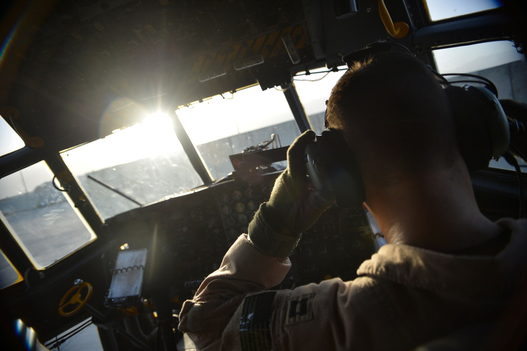U.S. Air Force Capt. Frank Von Heiland, 41st Expeditionary Electronic Combat Squadron co-pilot, prepares for a mission on an EC-130H Compass Call aircraft at Bagram Airfield, Afghanistan Sept. 12, 2014.  The 41 EECS provides premier counter-communications electronic attack capabilities. Von Heiland is deployed from Davis-Monthan Air Force Base, Ariz. and a native of Anaheim, Calif. (U.S. Air Force photo by Staff Sgt. Evelyn Chavez/Released)