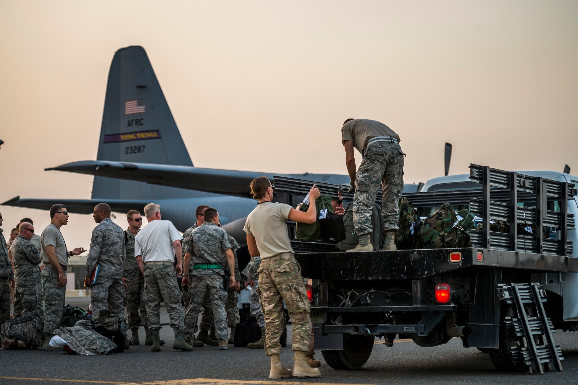 Airmen of the 934th Air Wing unload after landing at their new home Sept. 12, 2014 at an undisclosed location in Southwest Asia. The crews will be stationed with the 386th Air Expeditionary Wing for the next four months and deployed from Minneapolis-St Paul Air Reserve Station, Minn. in support of Operation Enduring Freedom. (U.S. Air Force photo by Staff Sgt. Jeremy Bowcock)