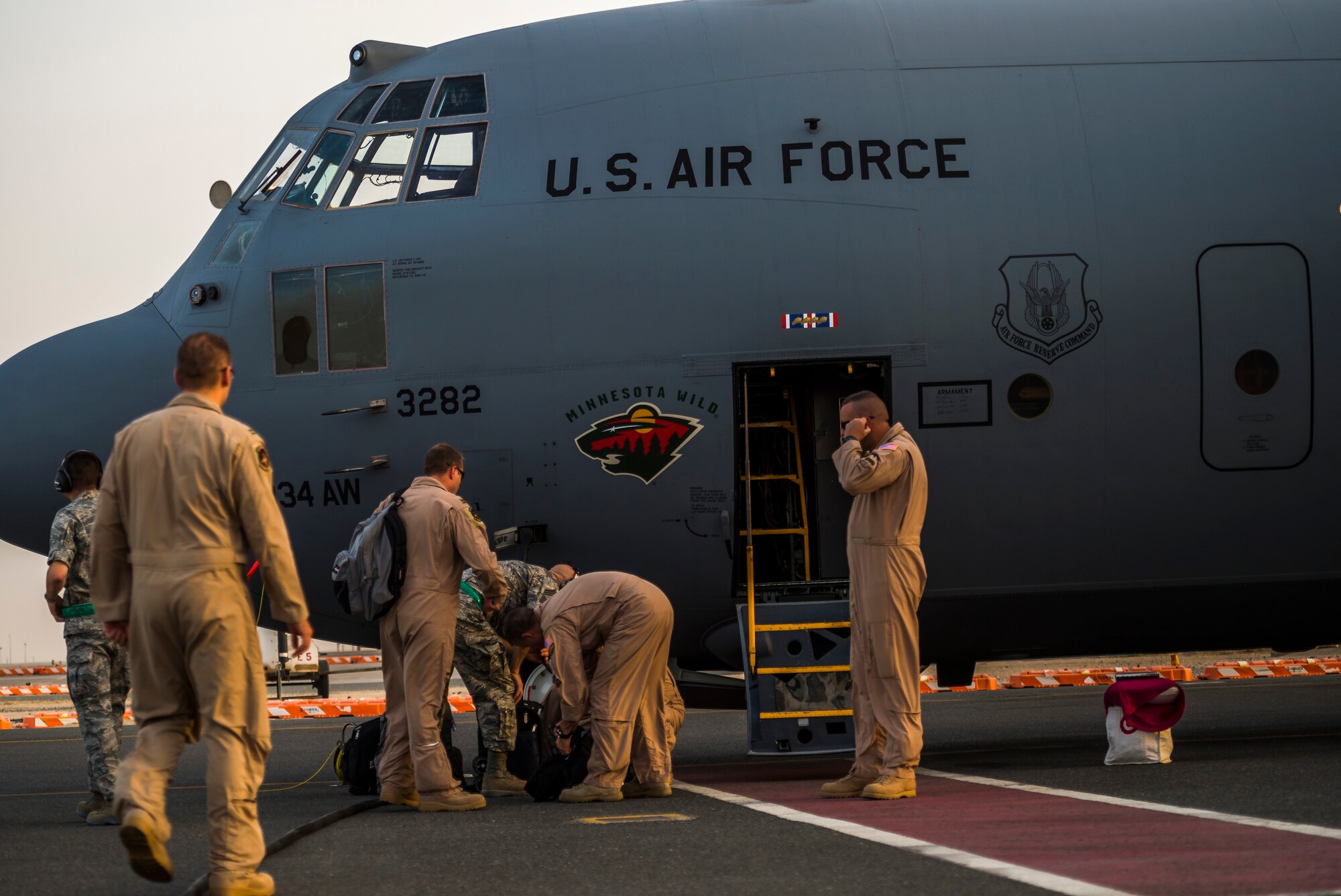 Airmen of the 934th Air Wing unload after landing at their new home Sept. 12, 2014 at an undisclosed location in Southwest Asia. The crews will be stationed with the 386th Air Expeditionary Wing for the next four months and deployed from Minneapolis-St Paul Air Reserve Station, Minn. in support of Operation Enduring Freedom. (U.S. Air Force photo by Staff Sgt. Jeremy Bowcock)