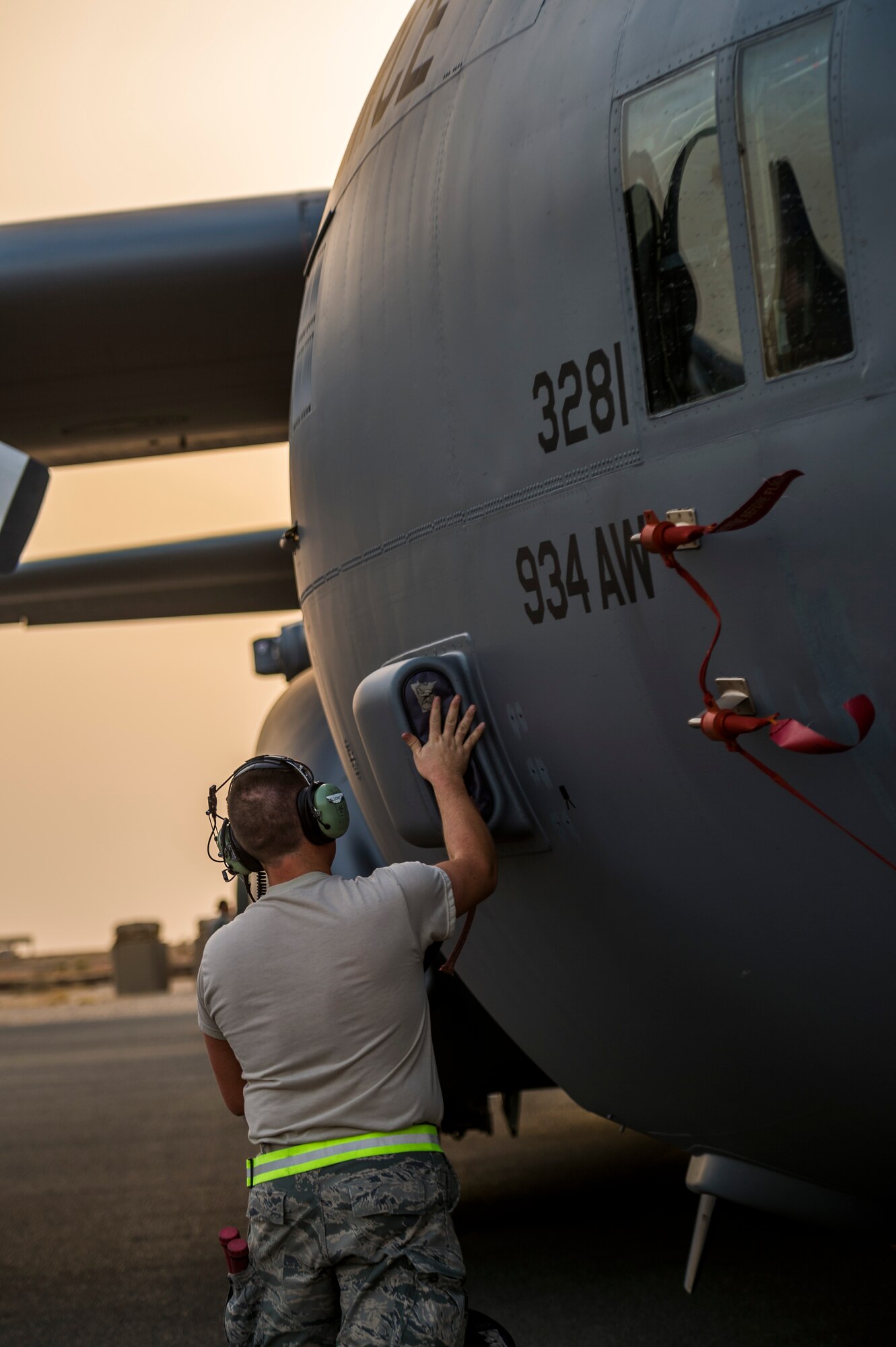 U.S. Air Force Senior Airman Sean Hallowell, 386th Expeditionary Aircraft Maintenance Squadron crew chief, installs plugs and covers on a C-130H Hercules after landing Sept. 12, 2014 at an undisclosed location in Southwest Asia. The crew will be stationed with the 386th Air Expeditionary Wing for the next four months and deployed from the 934th Airlift Wing, Minneapolis-St Paul Air Reserve Station, Minn. in support of Operation Enduring Freedom. (U.S. Air Force photo by Staff Sgt. Jeremy Bowcock)