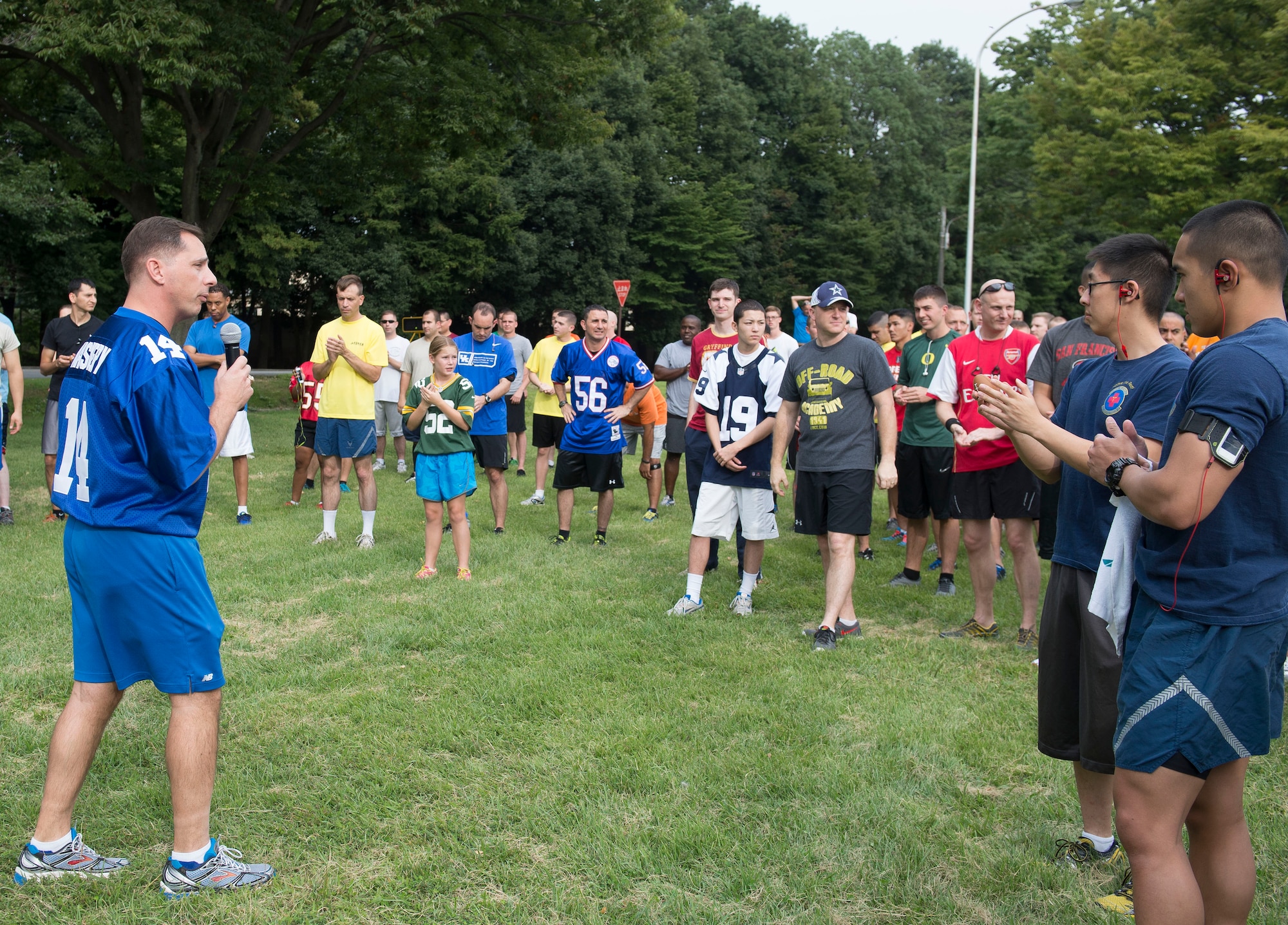 374th Mission Support Group Commander Col. Scott Maskery, speaks with Airmen before the football-themed wing fun run at Yokota Air Base, Japan, Sept. 19, 2014. Participants were able to raffle for prizes such as footballs, water bottles and free movie rentals. (U.S. Air Force photo by Airman 1st Class Meagan Schutter/Released)