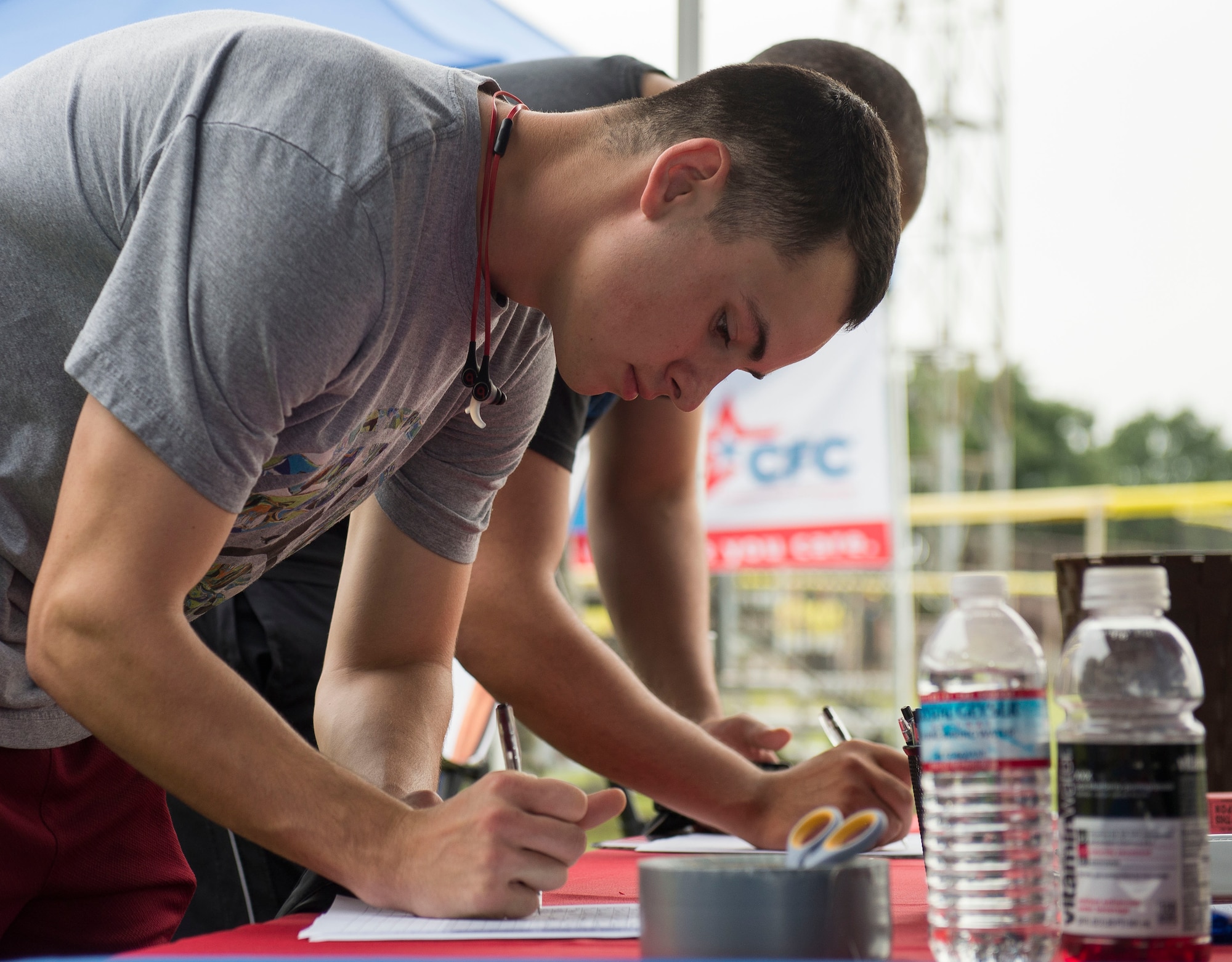 An Airman signs in at the wing fun run at Yokota Air Base, Japan, Sept. 19, 2014. The wing fun run gives Airmen the opportunity to connect with other squadrons and bond with families. (U.S. Air Force photo by Airman 1st Class Meagan Schutter/Released)
