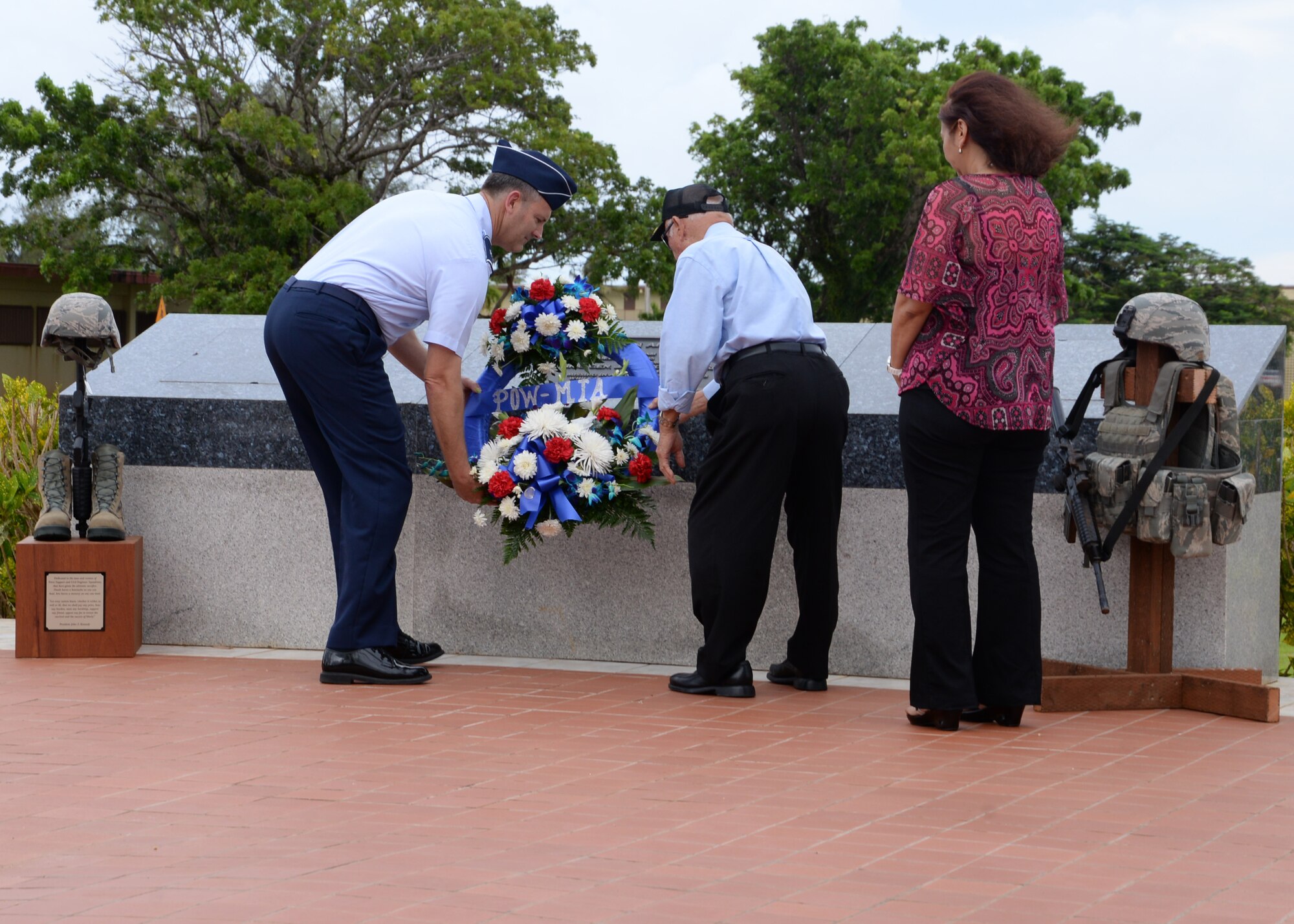 Brig. Gen. Andrew Toth, 36th Wing commander, and World War II Prisoner of War Francisco Carbullido place a wreath in front of Wing headquarters Sept.19, 2014, on Andersen Air Force Base, Guam. The retreat ceremony ended the week’s events that included a ruck march, a 5K run and challenge and a 24-hr vigilance run. (U.S. Air Force photo by Senior Airman Cierra Presentado/Released)