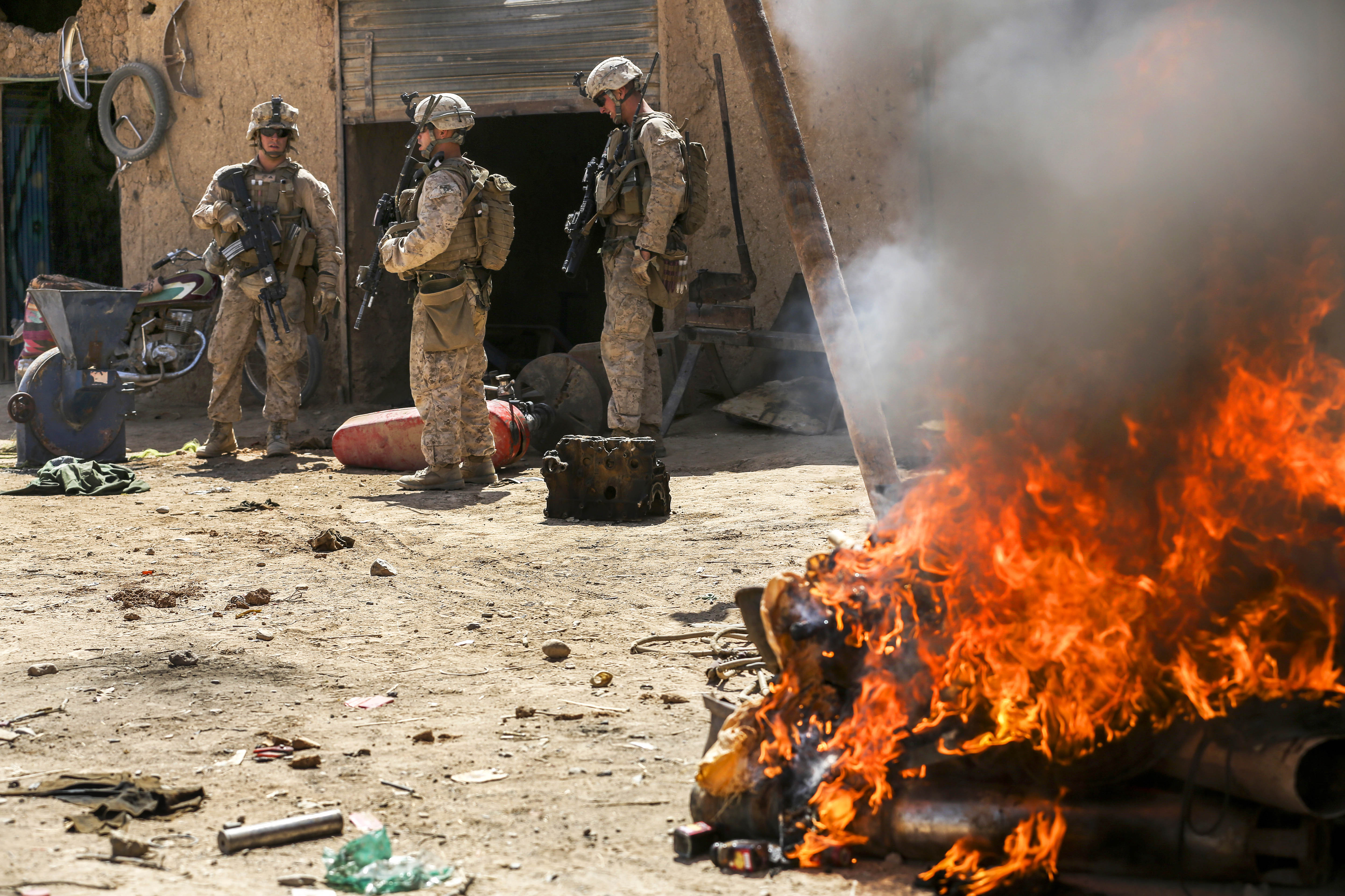 U.S. Marines use a thermite grenade to burn materials used for making ...