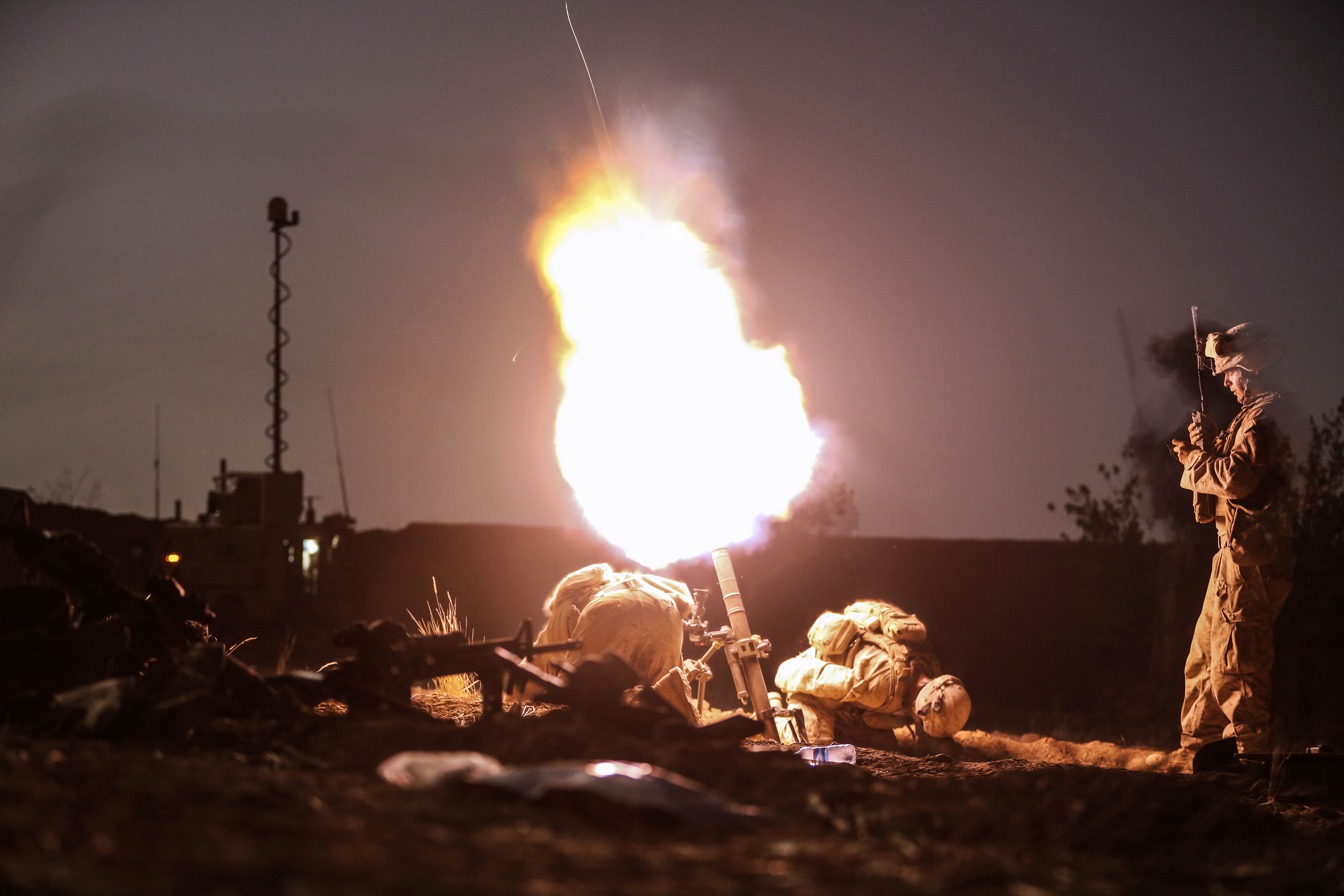 U.S. Marines launch illumination rounds from a mortar system during a