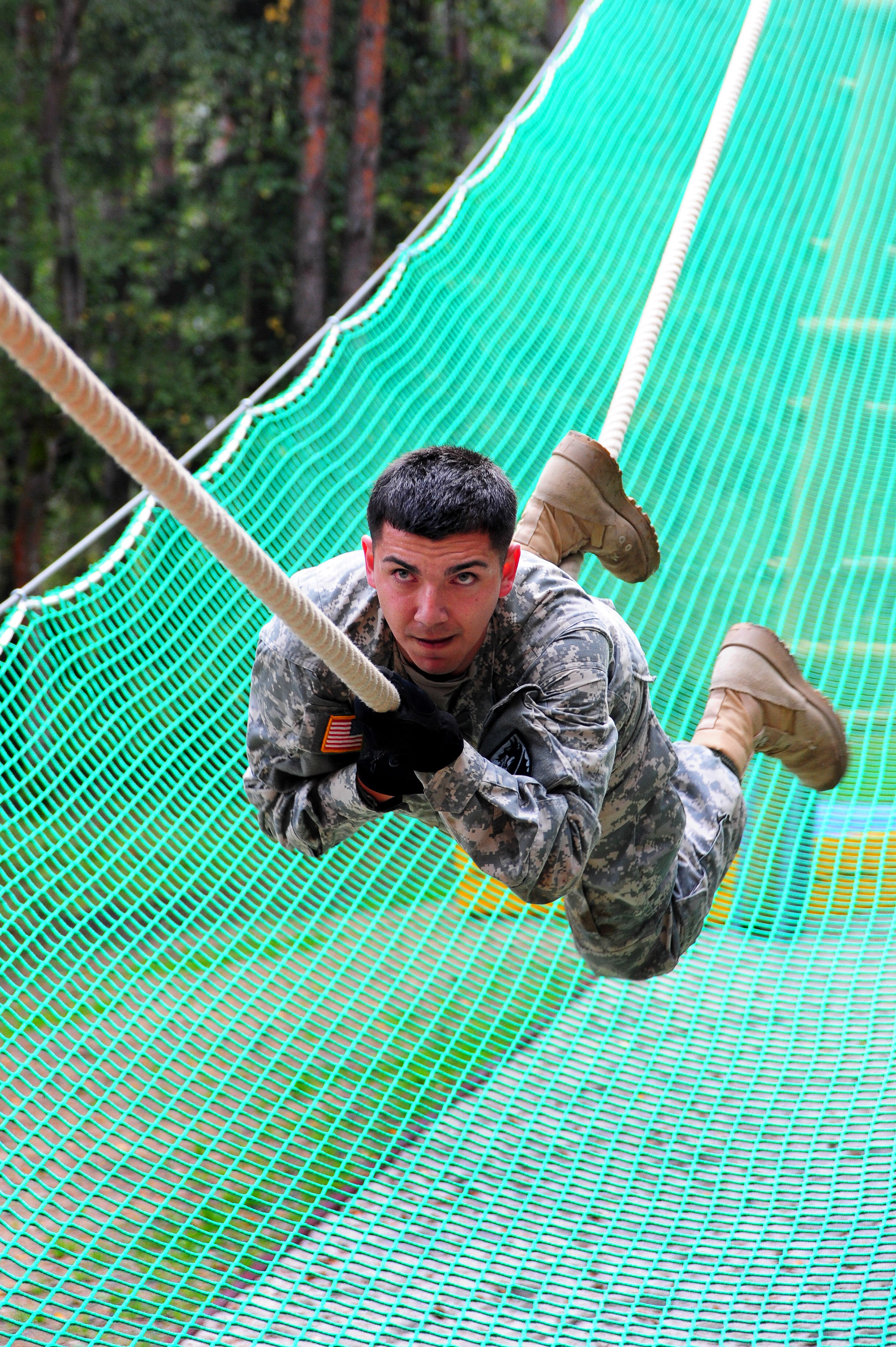 U.S. Army 2nd Lt. Octavio Mota negotiates the inverted rope climb obstacle  during the European Best