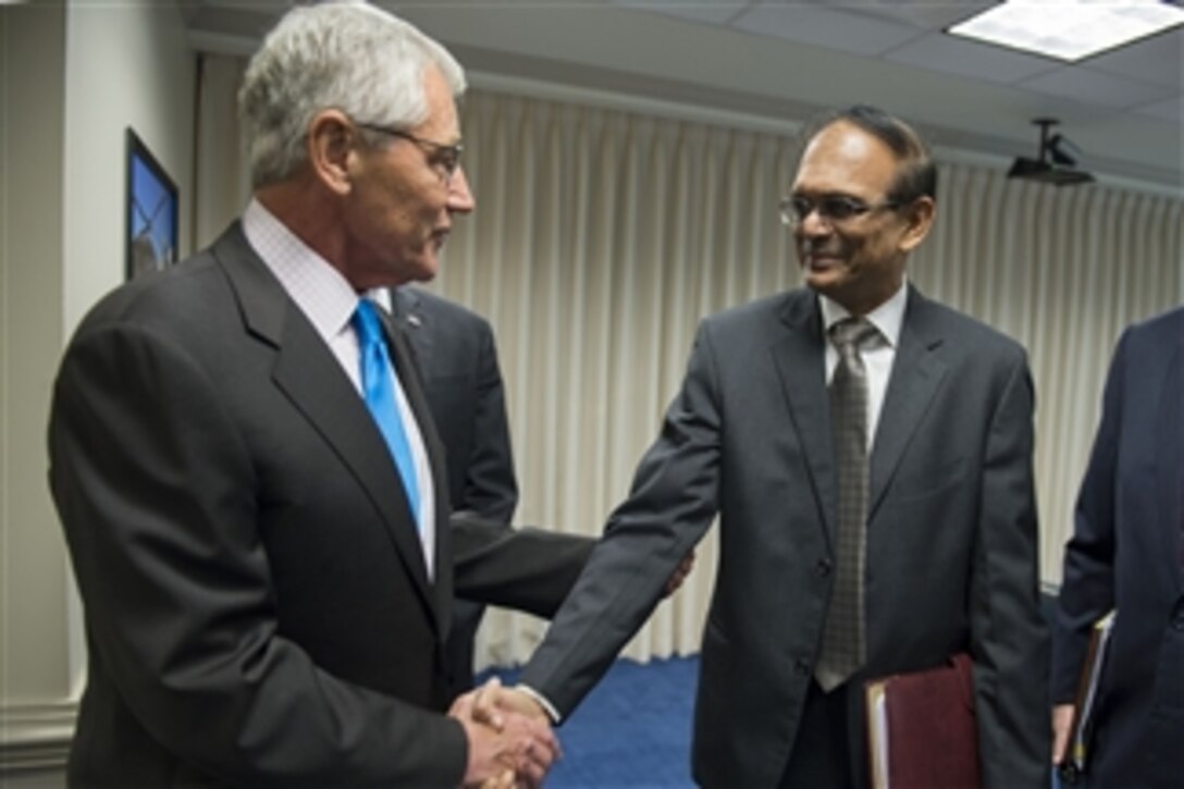 U.S. Defense Secretary Chuck Hagel greets Indian Secretary of Defense Production G. Mohan Kumar as he arrives at the Pentagon in Washington, D.C., for a meeting, Sept. 22, 2014. 