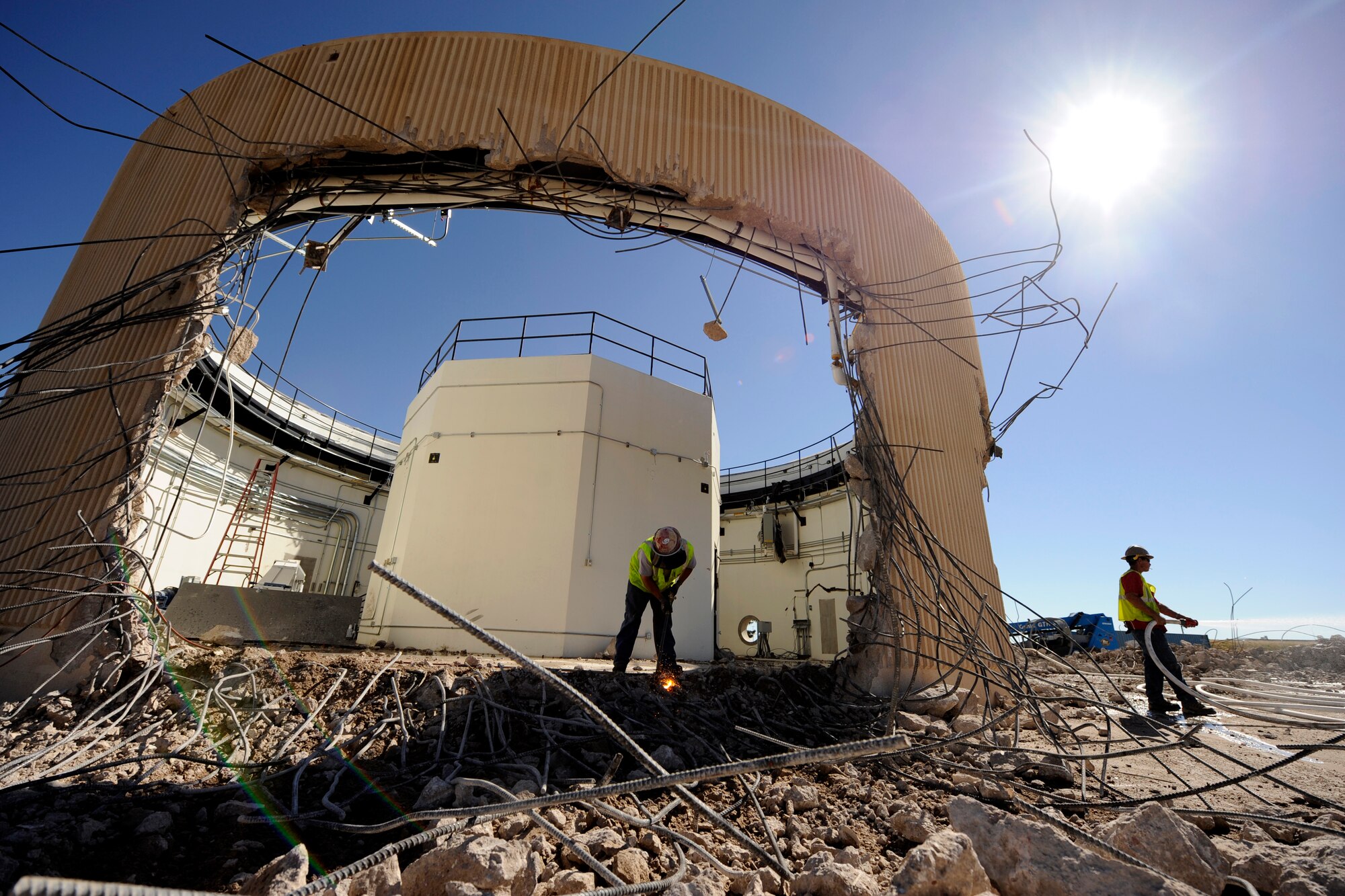 A demolition crew dismantles a Colorado Tracking Station antenna building Sept. 19, 2014, at Schriever Air Force Base, Colo. The 22nd Space Operations Squadron will officially decommission the tracking station, known as PIKE, during a ceremony Sept. 29, 2014. (U.S. Air Force photo/Dennis Rogers)