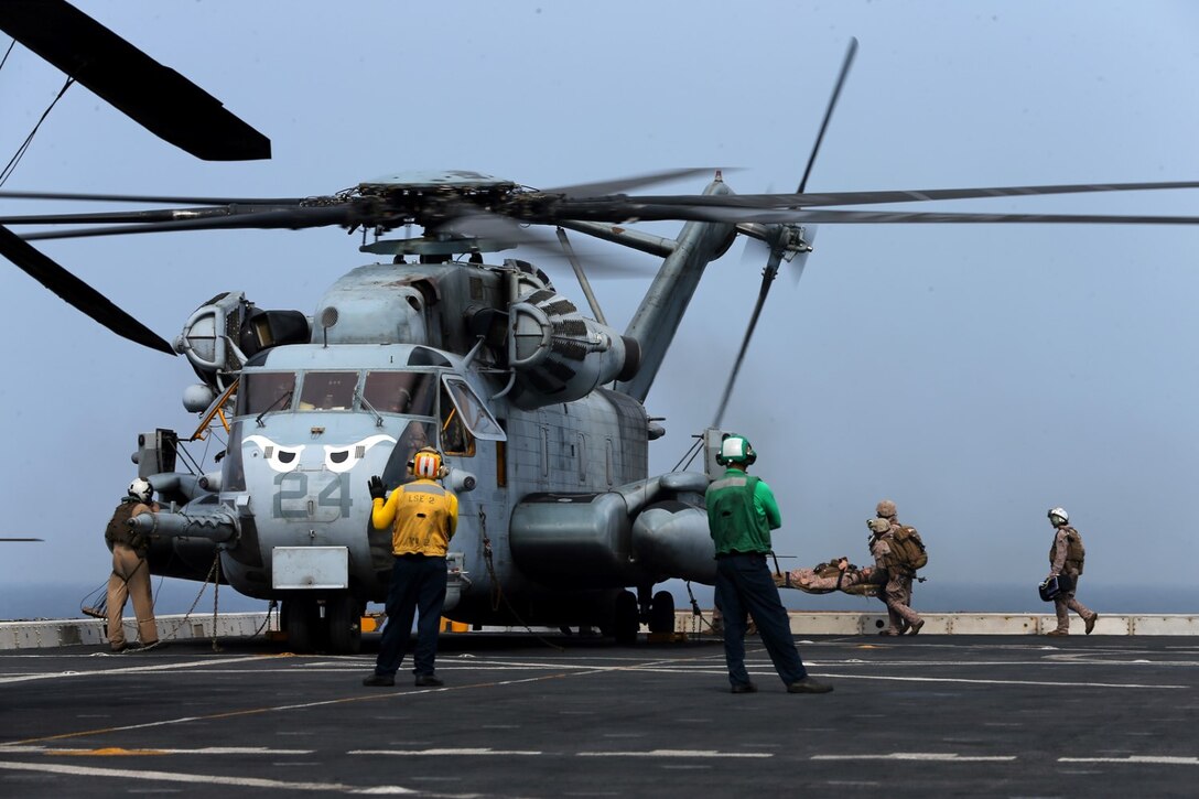 U.S. Navy hospital corpsmen with Combat Logistics Battalion 11, 11th Marine Expeditionary Unit (MEU), carry a simulated casualty to a CH-53E Super Stallion from Marine Medium Tiltrotor Squadron 163 (Reinforced), 11th MEU, as part of a mass casualty drill aboard the USS San Diego (LPD 22), Sept. 20. The 11th MEU is deployed with Makin Island Amphibious Ready Group as a theater reserve and crisis response force throughout U.S. Central Command and 5th Fleet area of responsibility. (U.S. Marine Corps photo by Cpl. Jonathan R. Waldman/Released)