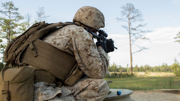 Marines with Charlie Company, 2nd Assault Amphibian Battalion, 2nd Marine Division, shoot at pop-up targets during a course of fire aboard Fort A.P. Hill, Va., Sept. 2, 2014.  The Marines spent the entire day shooting an unknown distance range with the M4 Carbine and the M249 squad automatic weapon to better themselves at estimating distances and eliminating a target.