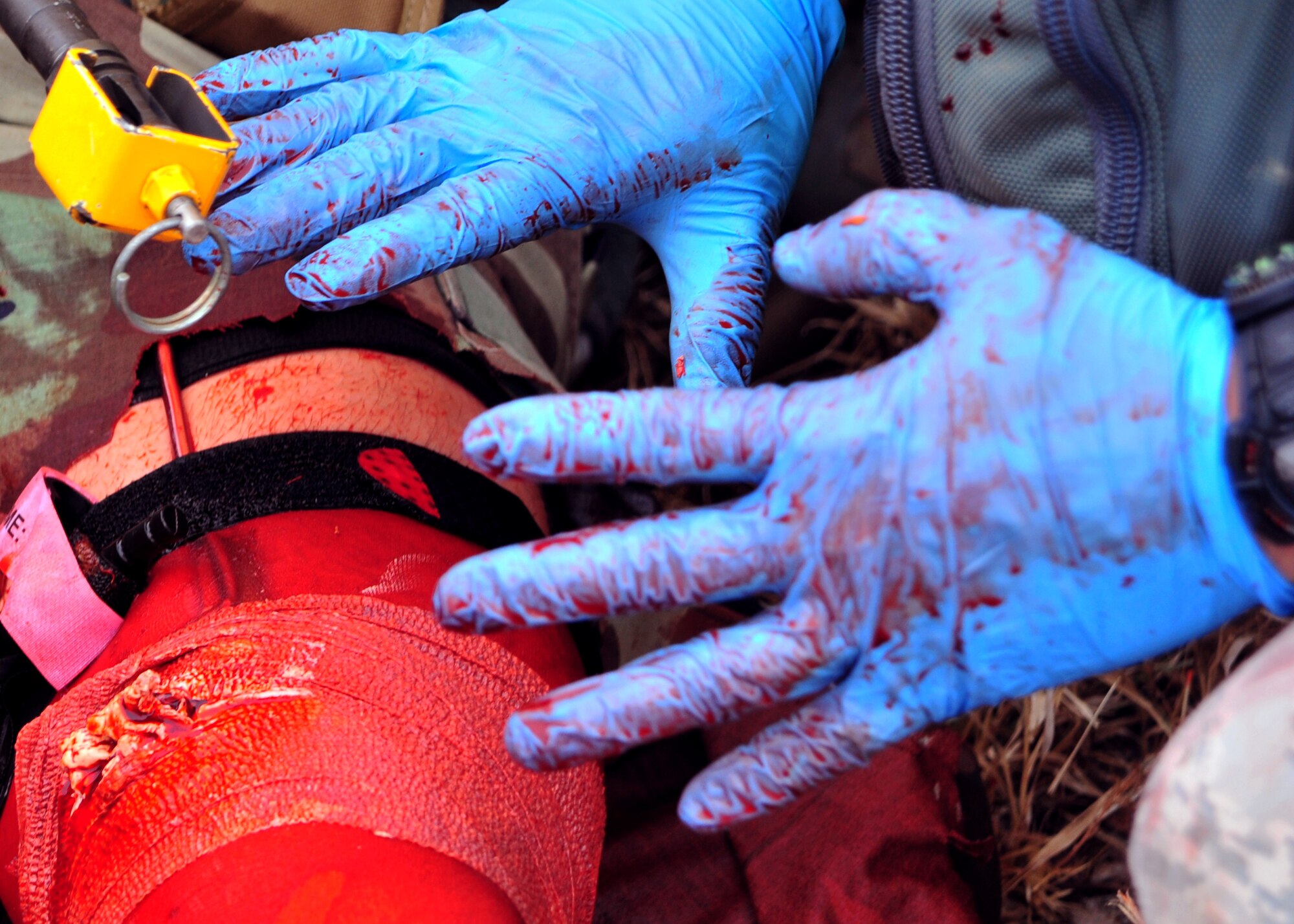 A U.S. Air Force Emergency Medical Technician prepares to apply pressure to a simulated gunshot wound during a scenario Sept. 12, 2014 at Melrose Air Force Range, N.M. During the Commando Challenge, an integral part of the EMT Rodeo, competitors were required to treat and transport patients in conditions similar to those which they may encounter downrange. (U.S. Air Force photo/Staff Sgt. Whitney Amstutz)