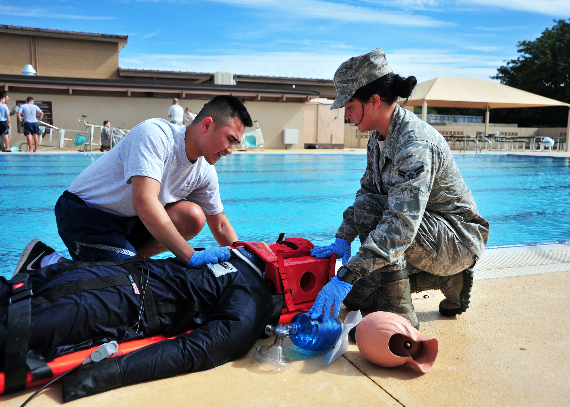 U.S. Air Force Airman 1st Class Tin Phan, 27th Special Operations Medical Operations Squadron Emergency Medical Technician, speaks to a simulated drowning victim while Airman 1st Class Roxanne Kennedy, 27 MDOS EMT, ensures head and neck stability during an EMT Rodeo scenario Sept. 13, 2014. Once the patient’s normal functions were restored, EMTs prepared the mannequin patient for transport. (U.S. Air Force photo/Staff Sgt. Whitney Amstutz)