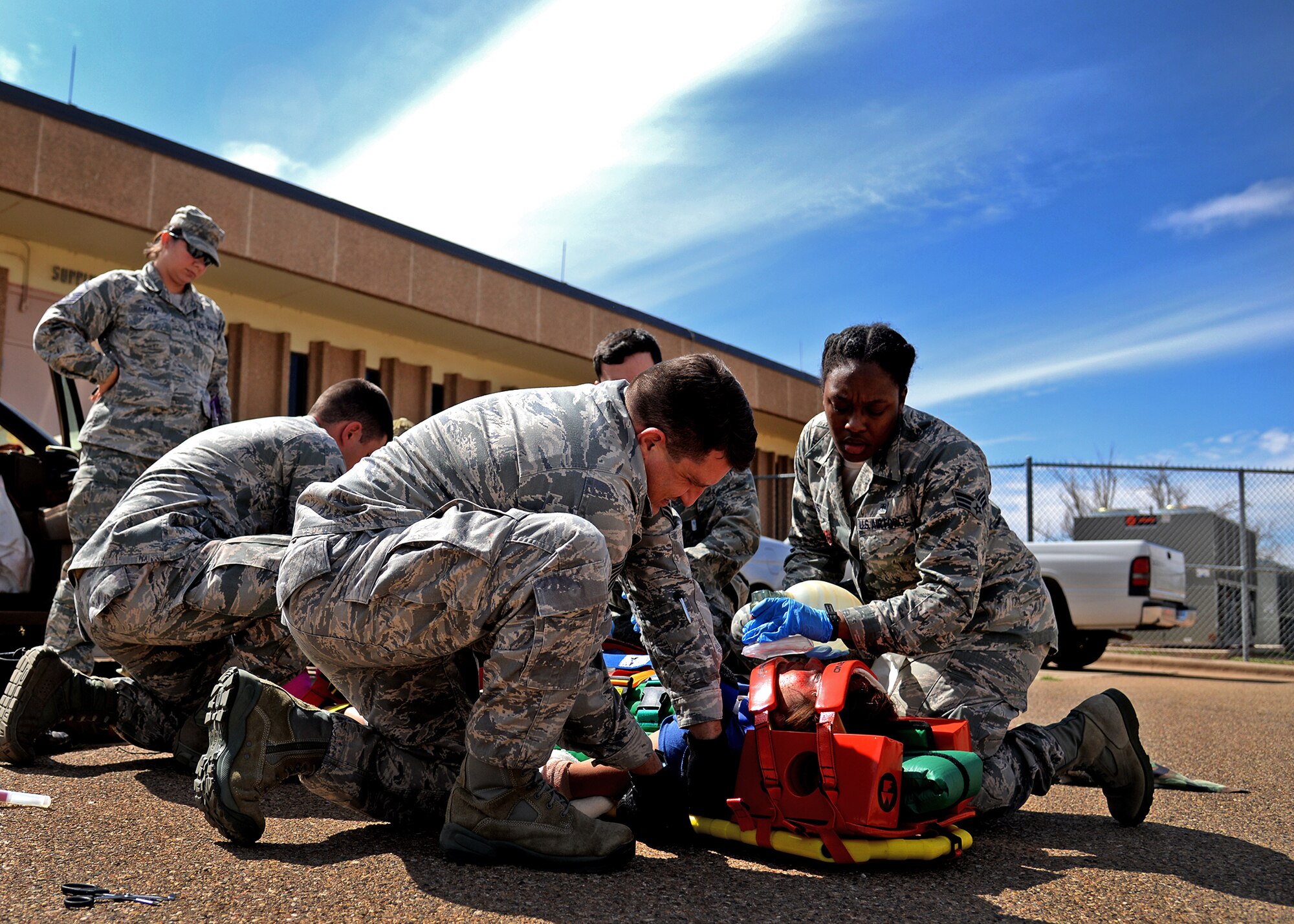 U.S. Air Force Emergency Medical Technicians respond to a victim during a simulated head-on collision Sept. 13, 2014 at Cannon Air Force Base, N.M. The scenario, which was part of the EMT Rodeo, created a real-world atmosphere for the EMTs, and tested their ability to maintain professionalism during extreme situations. (U.S. Air Force photo/Airman 1st Class Chip Slack)