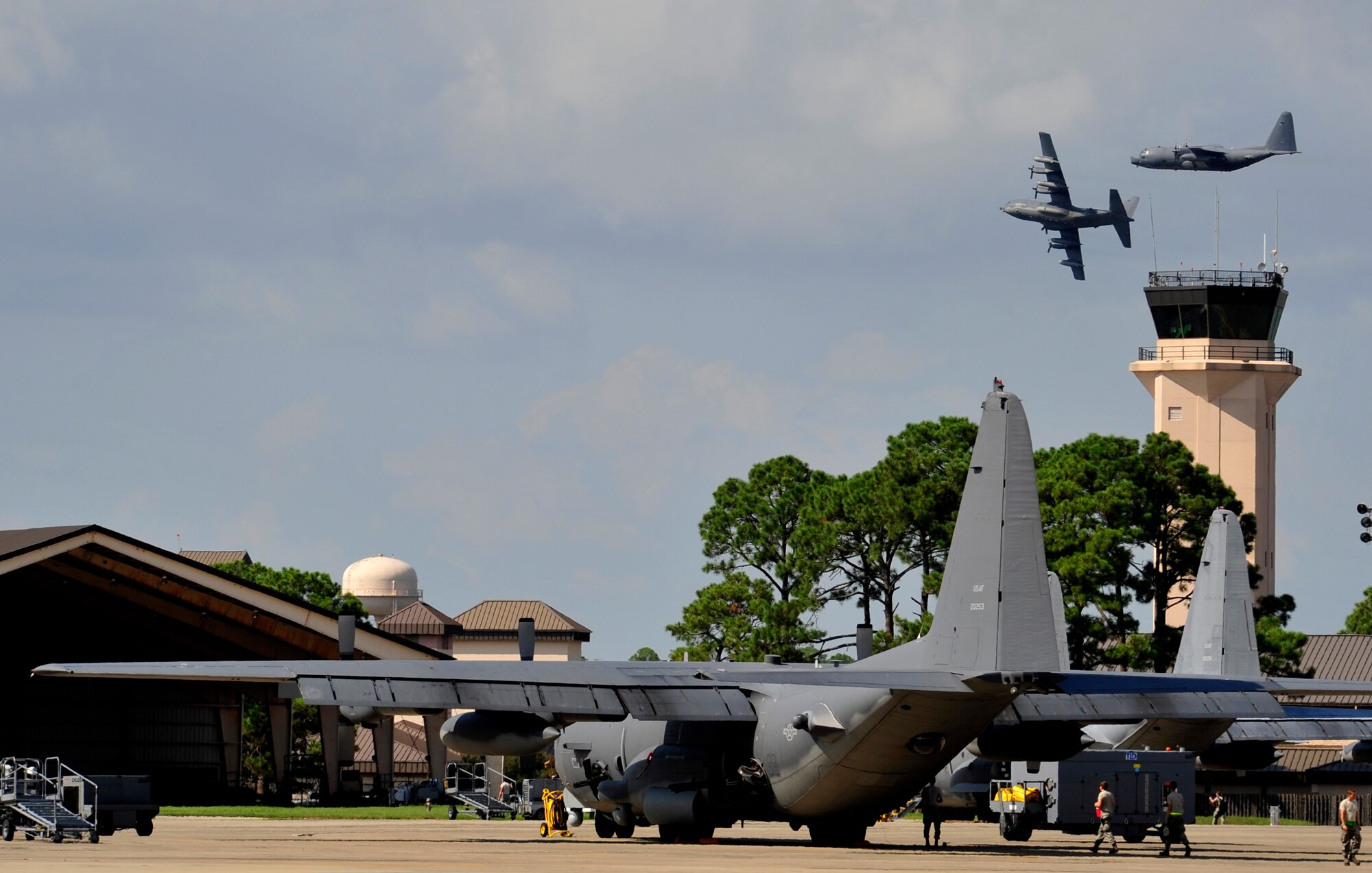 Two MC-130P Combat Shadows perform a fly-by over the control tower at Hurlburt Field, Fla., Sept. 19, 2014. The Combat Shadows completed their final combat deployment. The entire fleet will be retired next summer. (U.S. Air Force photo by Staff Tyler Placie)                               