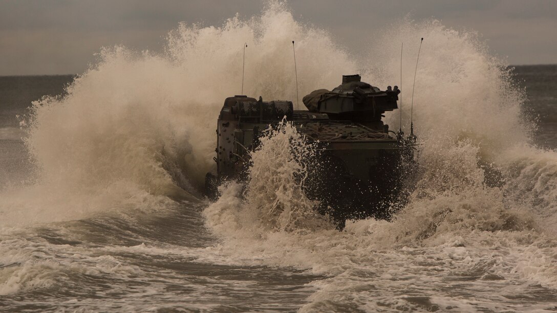 Marines with Alpha Company, 2nd Assault Amphibian Battalion, 2nd Marine Division, smash into a wave while driving into the ocean to test their assault amphibious vehicles aboard Camp Lejeune, N.C., Sept. 9, 2014. After returning from Fort A.P. Hill, Va., the Marines with Alpha Company went from conducting land operations to water operations with their AAVs. 