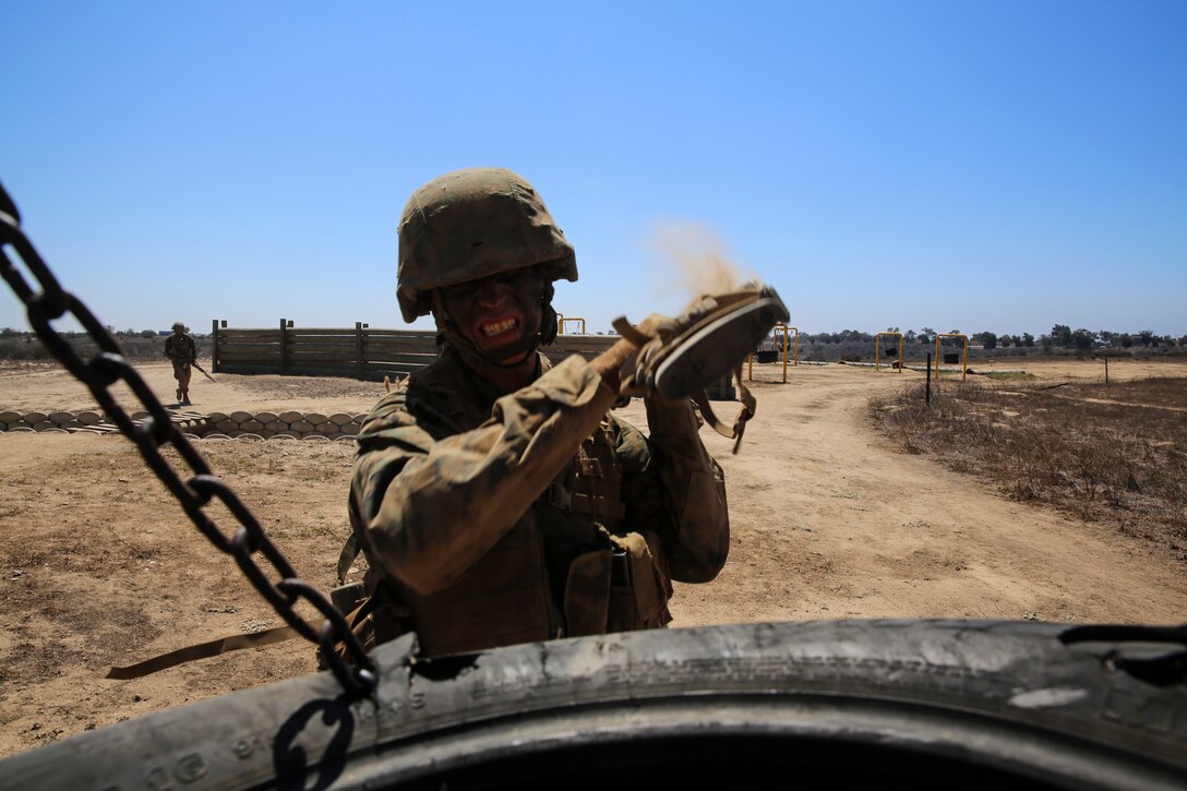 A recruit from Kilo Company, 3rd Recruit Training Battalion, executes a vertical butt-stroke against a simulated enemy at Edson Range, Marine Corps Base Camp Pendleton, Sept. 10. The recruits ran through a similar course multiple times throughout recruit training; each time they integrated new techniques and lessons they learned throughout training. 
