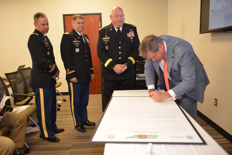 Nashville Mayor Karl Dean signs the Tennessee Silver Jackets Charter at Metro Nashville’s Development Services Center Sept. 23, 2014. Silver Jackets is an innovative program that provides an opportunity to consistently bring together multiple state, federal, and local agencies to learn from one another and apply their knowledge to reduce risk.