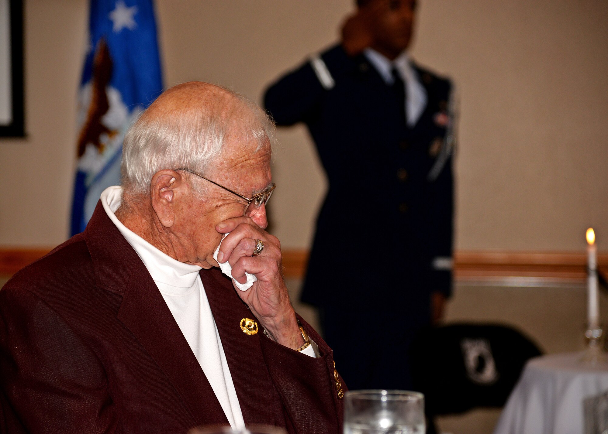 Dan McKinney, former Prisoner of War and the 7th inductee into the Hall of Heroes, weeps during a presentation at the POW/Missing in Action luncheon Sept. 17, 2014 at Cannon Air Force Base, N.M. The luncheon served as an opportunity to honor those service members and their families who have experienced the trauma of a loved one becoming POW/MIA. (U.S. Air Force photo/Airman 1st Class Chip Slack)