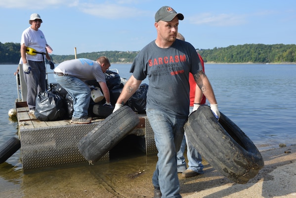 Volunteers unload mounds of trash from a barge at the Waitsboro Recreation area in Somerset, Ky, Sept. 9, 2014 in celebration of National Public Lands Day.  Volunteers hauled 386 bags of trash and debris from five designated recreation sites during the 25th Annual Lake Cumberland Cleanup.   The Friends of Lake Cumberland and U.S. Army Corps of Engineers Nashville District organized the event that resulted in the collection of 1,156 bags of trash, 268 old tires and plastic bottles along the shoreline and on public lands.  
