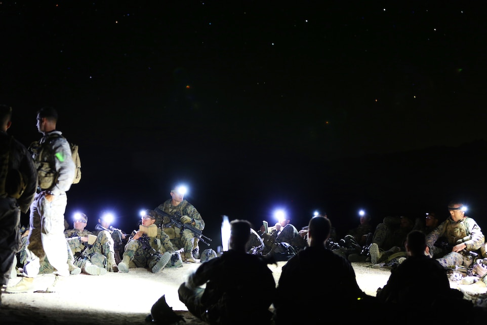 Students with Infantry Officers Course 4-14 debrief after conducting a long-range vertical insert during the multi-objective training exercise, Exercise Talon Reach IV at Range 220, Sept. 19. The exercise allowed the prospective infantry officers to demonstrate and refine operational reach, digital interoperability and expeditionary capabilities of the Company Landing Team. (Official USMC photo by Cpl. Lauren A. Kurkimilis/Released)