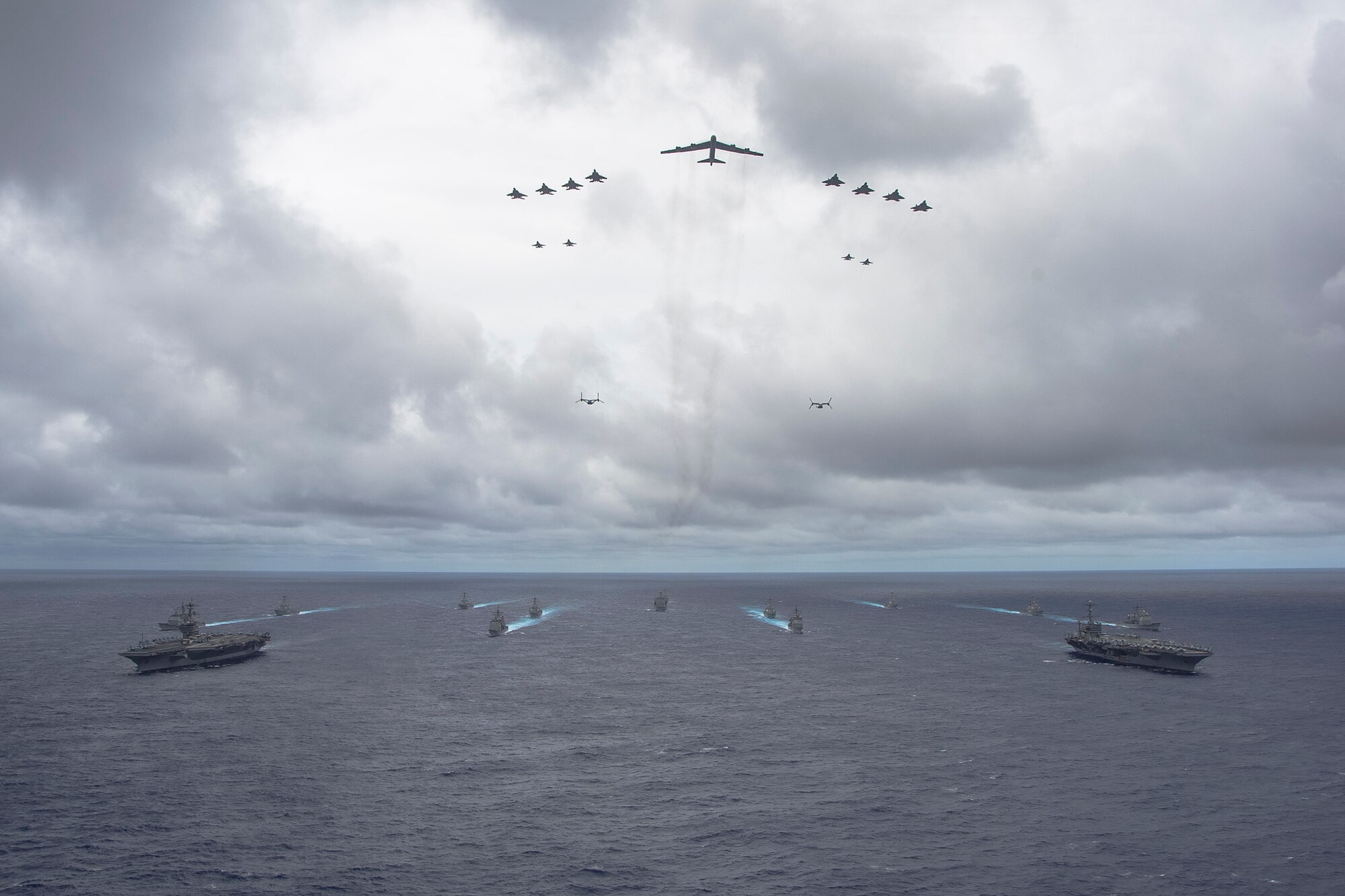 U.S. Navy ships from the George Washington and Carl Vinson Carrier Strike Groups and U.S. Air Force and Marine Corps aircraft operate in formation Sept. 23, 2014, at the conclusion of Valiant Shield 2014. Exercises like VS 14 provide the U.S. military the opportunity to integrate joint assets in an Air-Sea Battle environment, refining the military’s ability to defend U.S. interests and those of its allies and partners in the Pacific region. (U.S. Navy photo by Mass Communication Specialist 1st Class Trevor Welsh/Released)