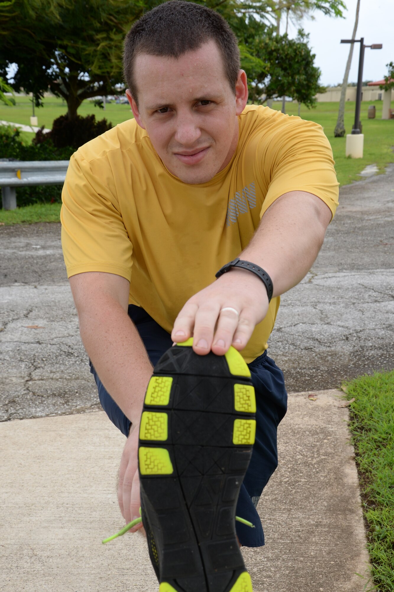 Petty Officer 2nd Class Beau Korbe, Naval Computer Telecommunications Station Guam information systems technician, stretches during a 24-hr vigilance run to recognize prisoners of war and those missing in action recognition week Sept. 19, 2014, on Andersen Air Force Base, Guam. Korbe ran for a full 24 hours to honor our POW/MIA and finished the run with 58.29 miles. (U.S. Air Force photo by Senior Airman Cierra Presentado/Released)