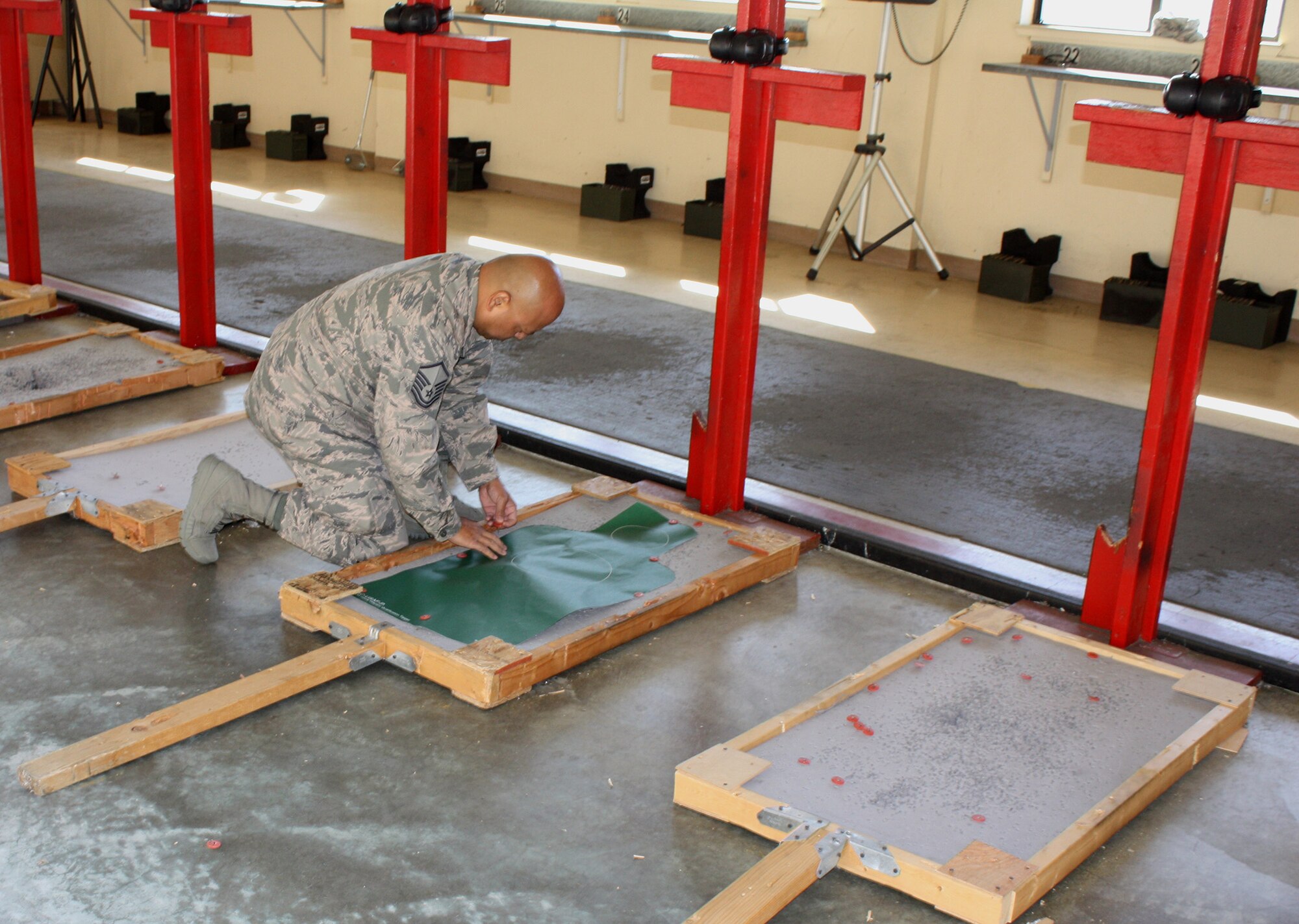 TRAVIS AIR FORCE BASE, Calif. -- Master Sgt. James Muna prepares his target for practice at the Travis AFB range. A recruiter with the 349th RS, he joined his squadron mates for a team building exercise in firing the M4 and M9 weapons. The 349th AMW recruiters finished out fiscal year 2014 by exceeding their goal of 270 accessions, and were meeting to plan for another successful year in 2015. (U.S. Air Force photo/Senior Master Sgt. Alexander Brown)
